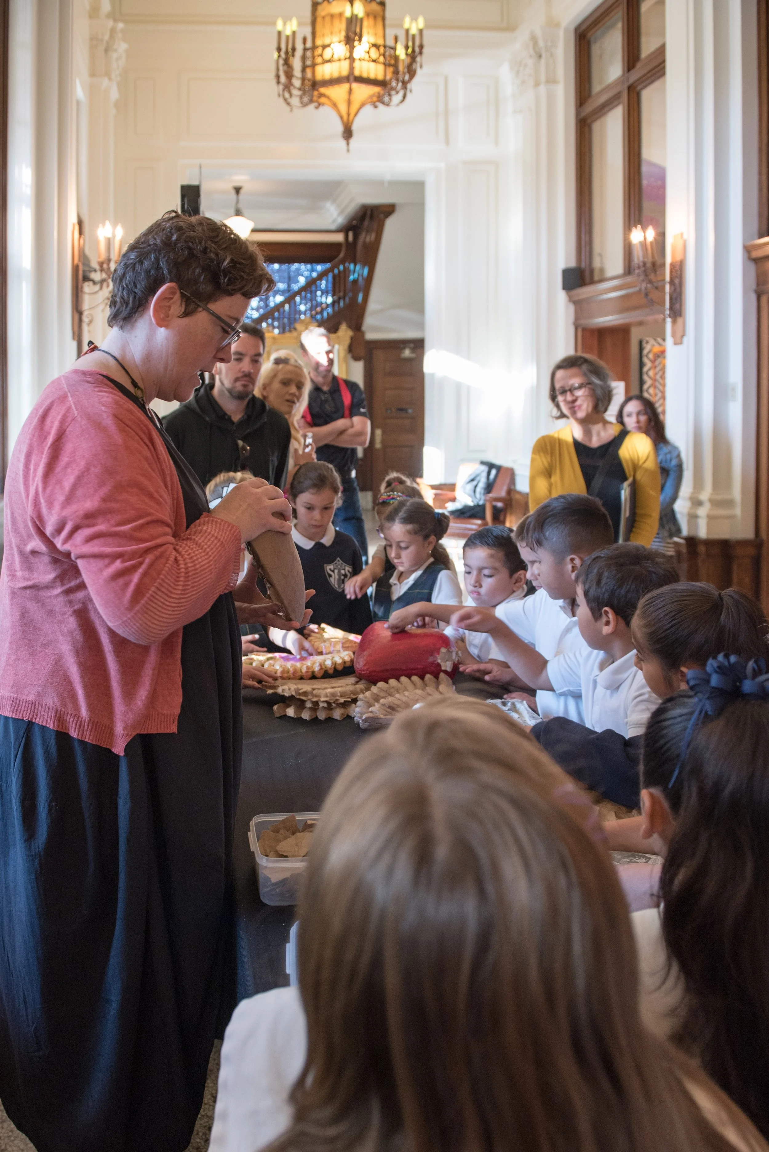 Children listening to a presentation about the art