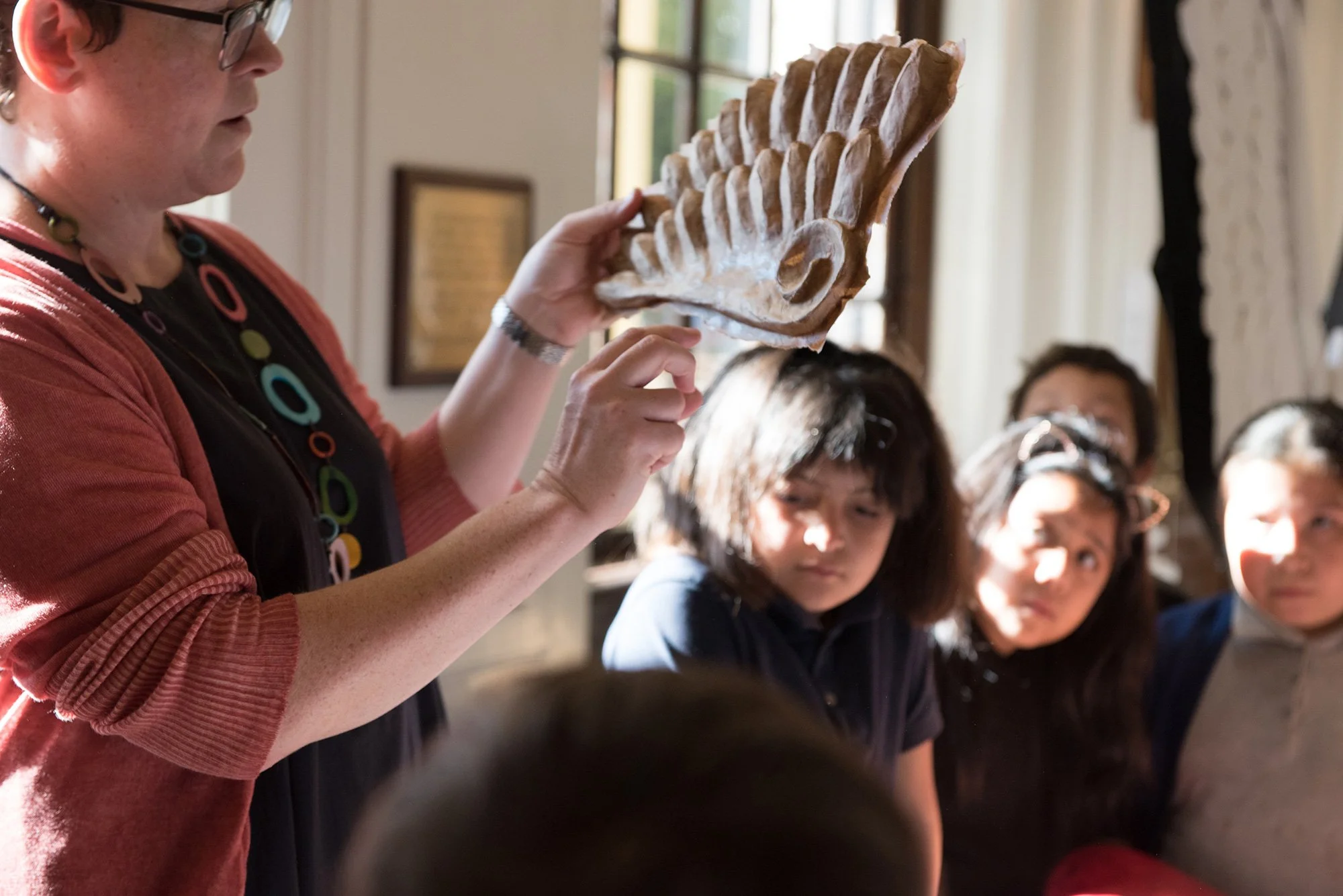 Children listening to a presentation about the art