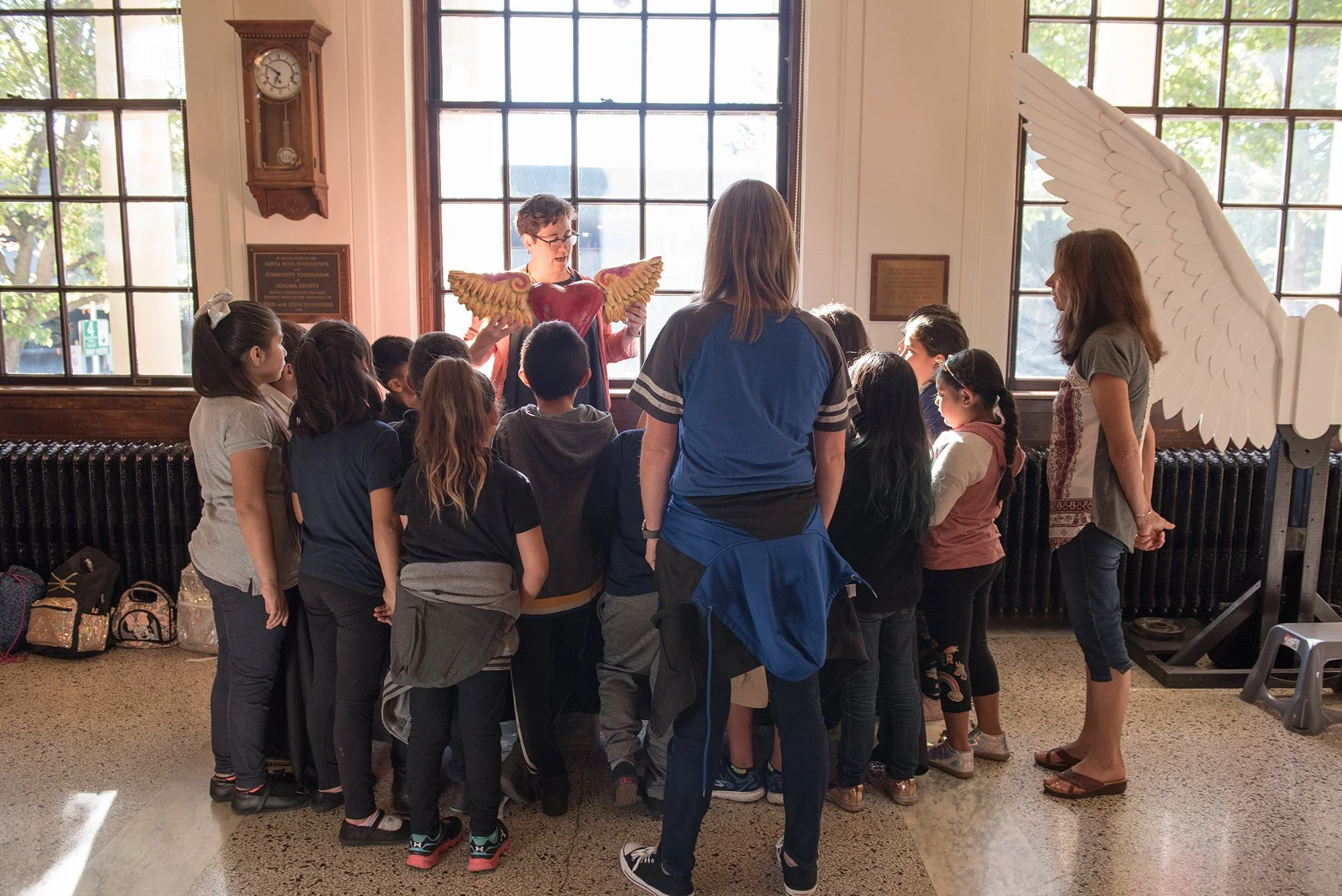 Children listening to a presentation about the art