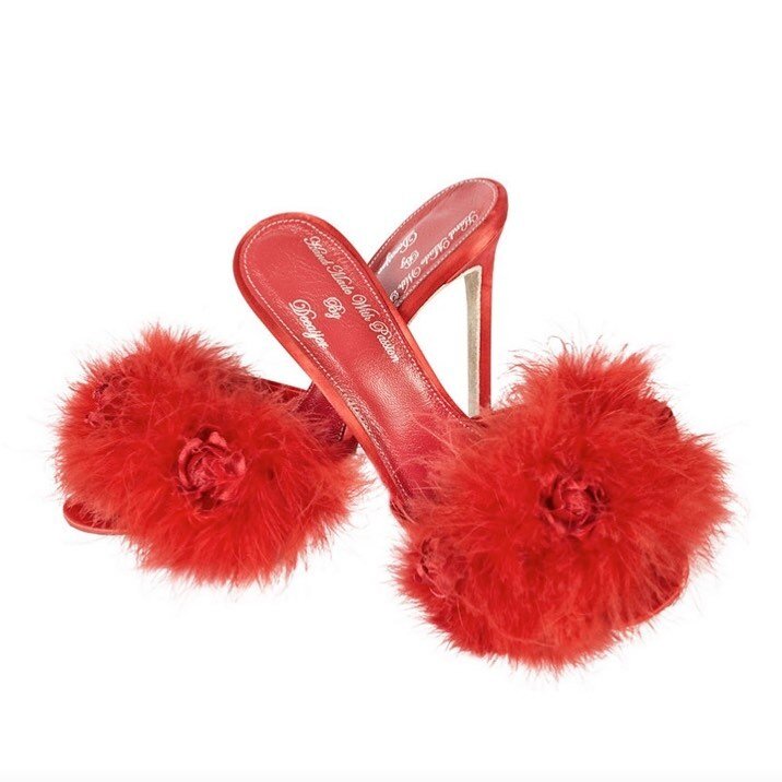 Marilyn red mule heel slippers, with leather sole, layered memory foam insoles, 4&rdquo; heels, silk / satin uppers and hairsheep leather lining, marabou and ostrich feather mix embellishments; made by Deeasger in West Hendon. They are one of around 