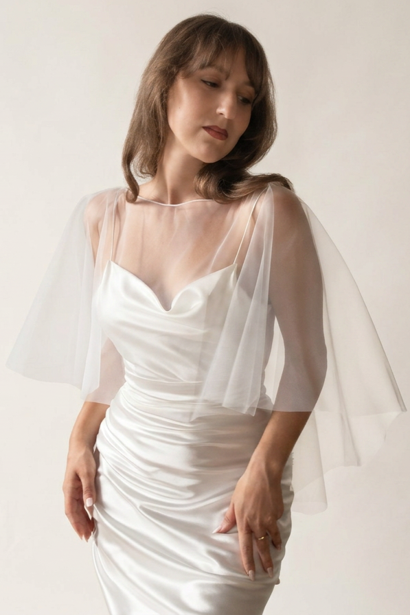 A bride wearing a soft ivory wedding shawl