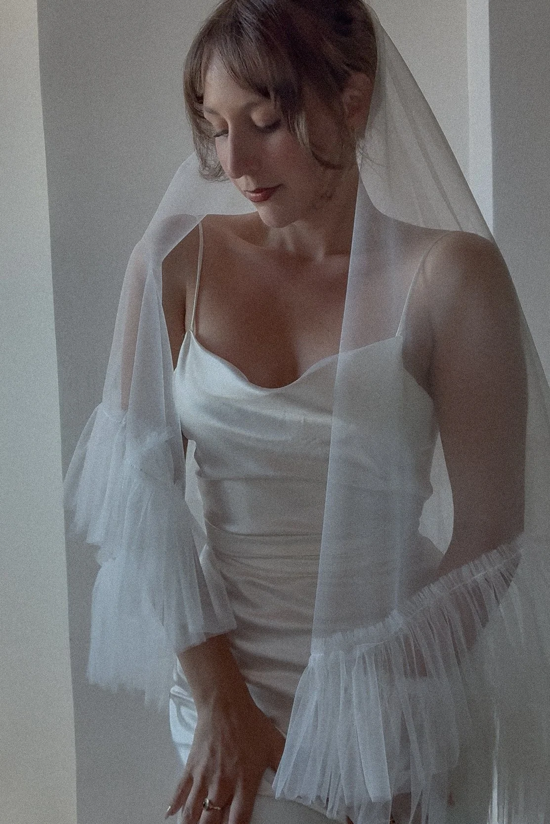 Soft two-tier wedding veil featuring a graceful frilly edge and lightweight tulle