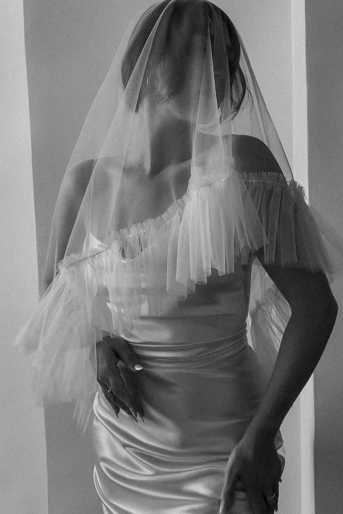 A bride in a two-tiered bridal wedding veil with a frilly edge