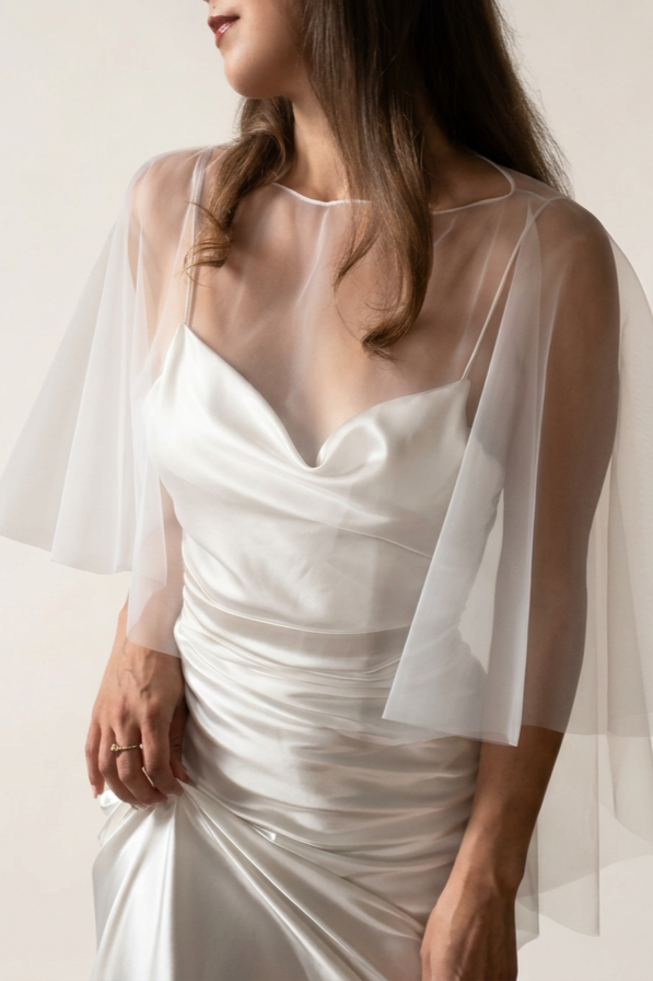 Bride wearing a soft tulle bridal cape.