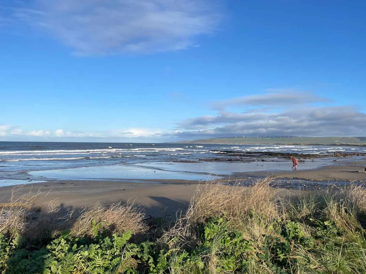 Blue skies over a sandy bay.