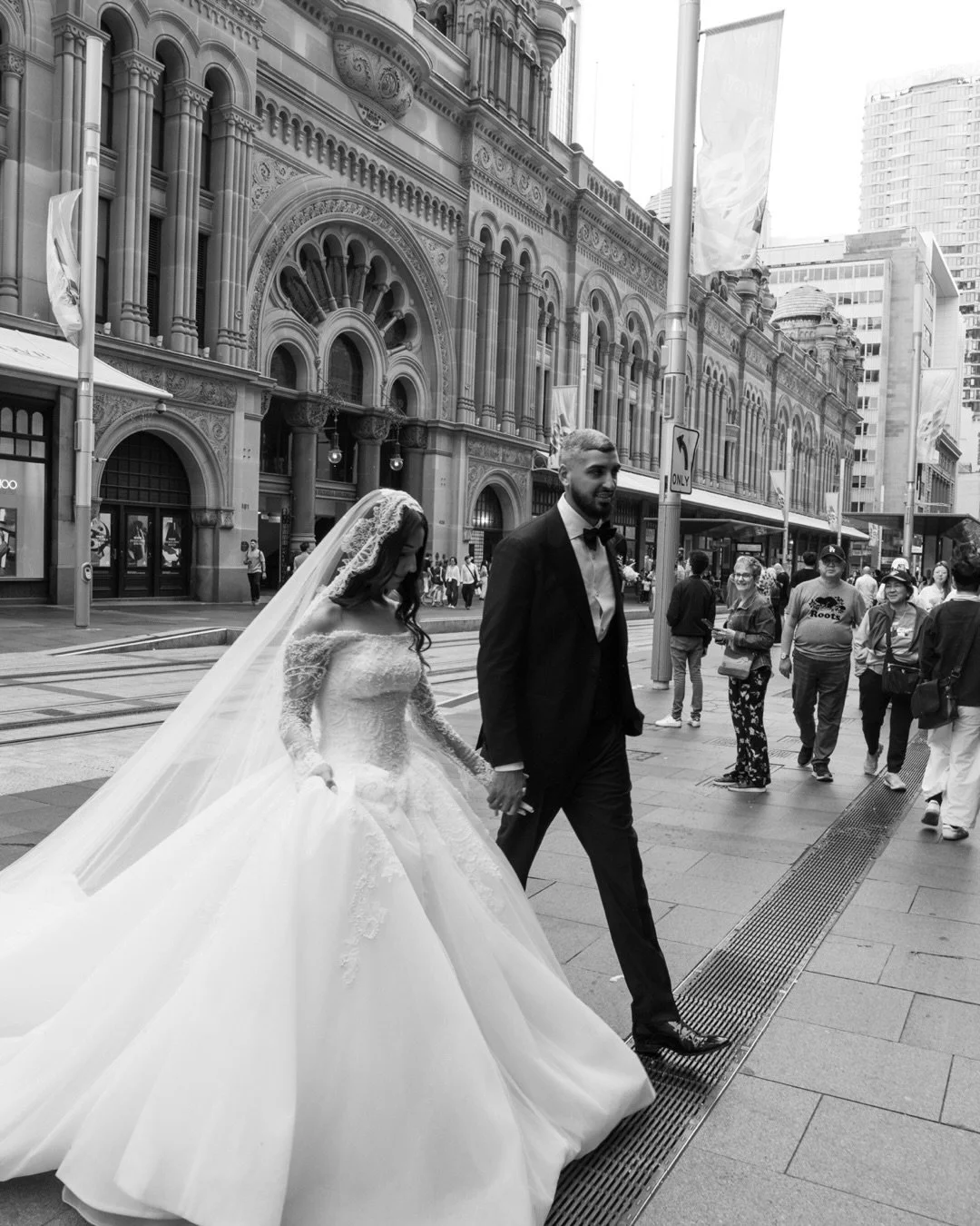 Hand in hand through the city that watched the journey begin. Taking slow quiet moments in the city noise. #weddingsydney #sydneybride