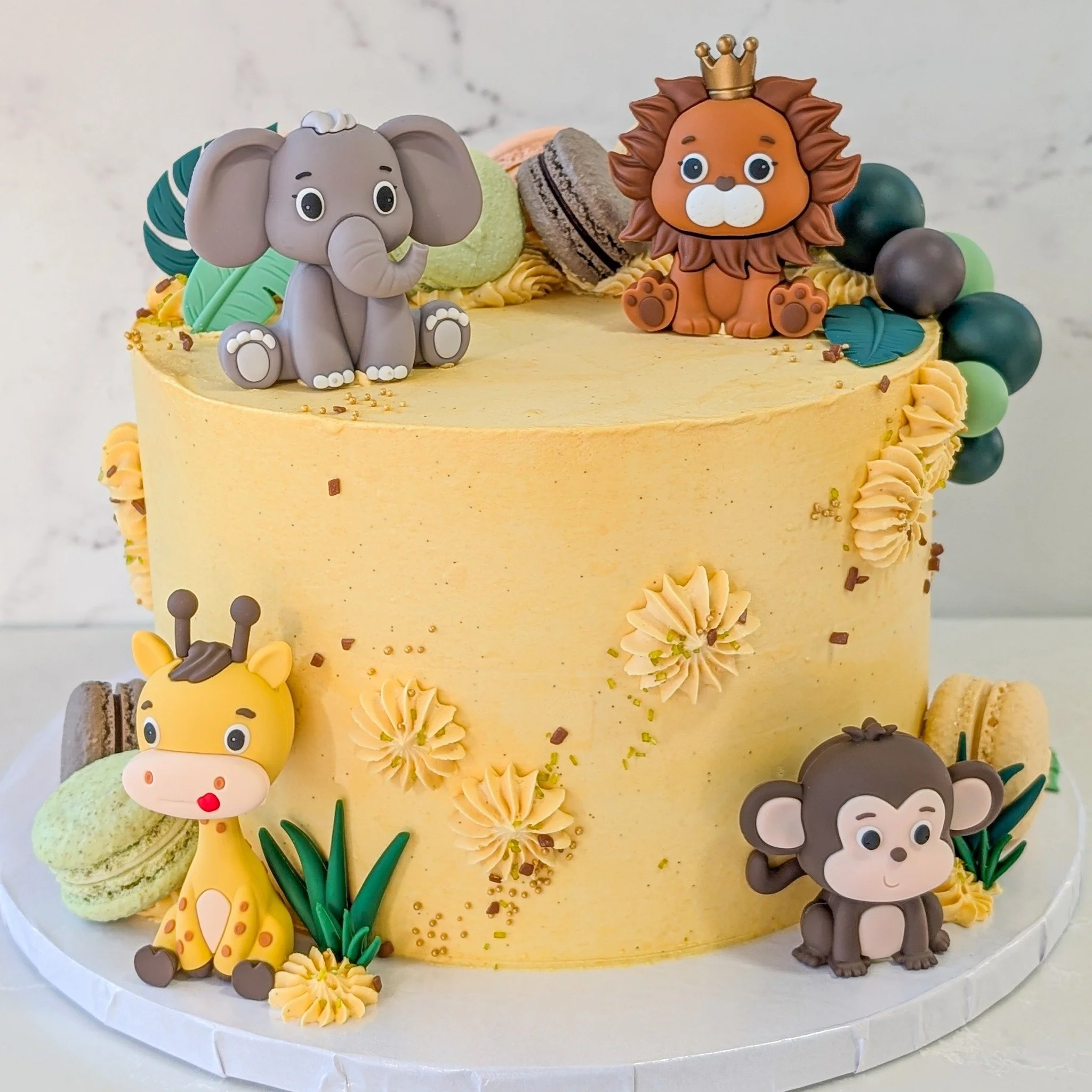 This is such a fun cake, the little animals are so cute too! 
.
To order your own custom cake:
Email us here: info@whiskandarrow.com
or call us: 920-815-3645
.
-Cake details-
Size: 8-inch premium
Add-ons: yellow buttercream + animal and leaf toppers 