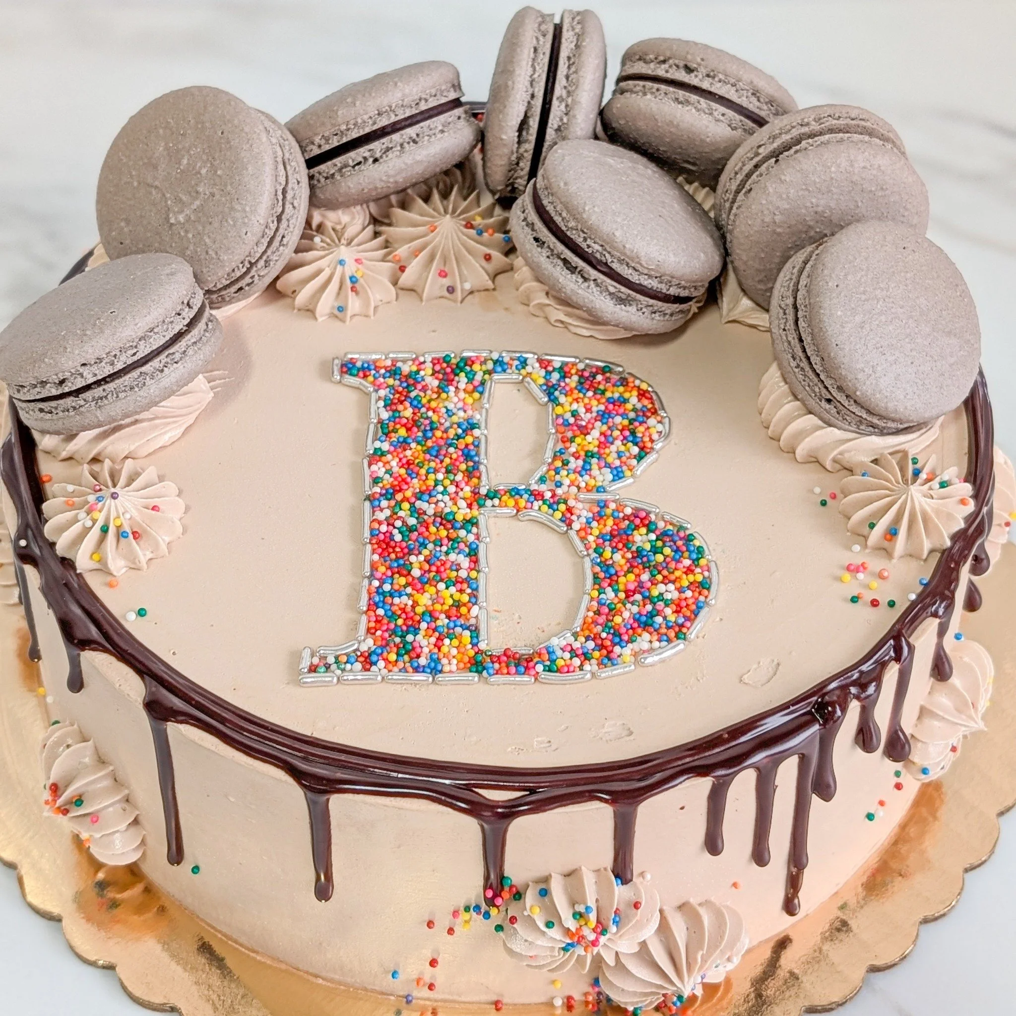 The sprinkle letters and numbers always look so cool! You can't go wrong with all these chocolate macarons. 
.
To order your own custom cake:
Email us here: info@whiskandarrow.com
or call us: 920-815-3645
.
-Cake details-
Size: 10-inch shorty
Add-ons
