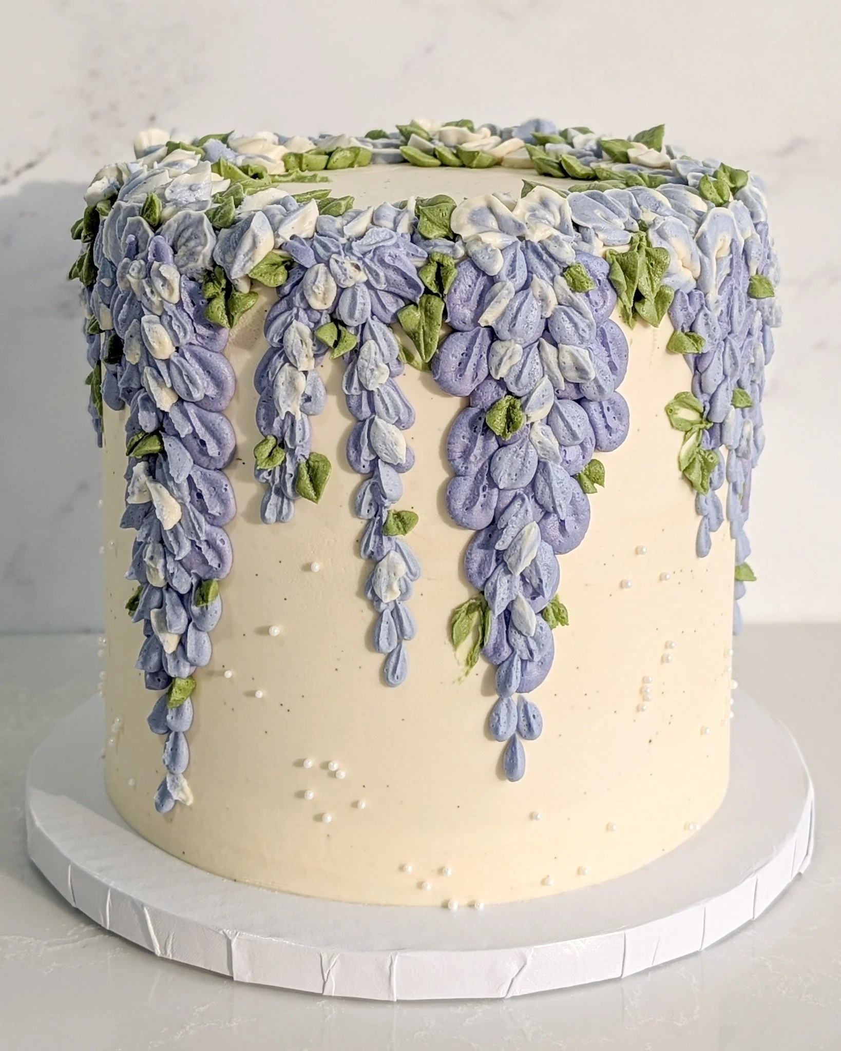Look at this whimsical wisteria inspired cake that Chef Sierra whipped up! It sort of reminds me of sitting underneath a giant willow tree in the springtime. The colors are so lovely, and all the pretty leaves and petals draping around give it such a
