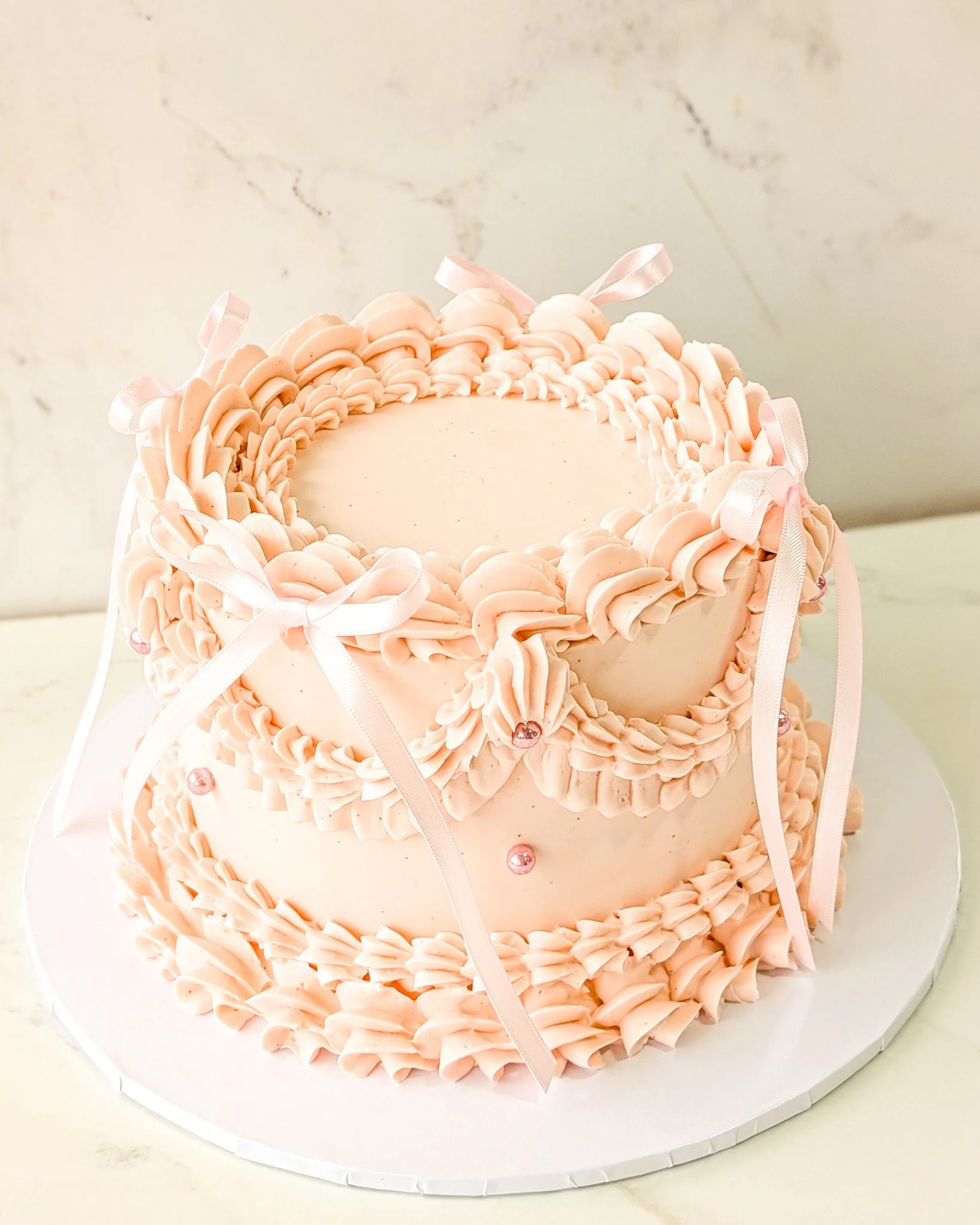 This cake is so simple and sweet! The buttercream detailing gives it a more elegant feeling and the bows really pull it all together. 
.
We can make any of our cakes look like this. There is a $40 upcharge for this design.
.
This cake flavor is our n
