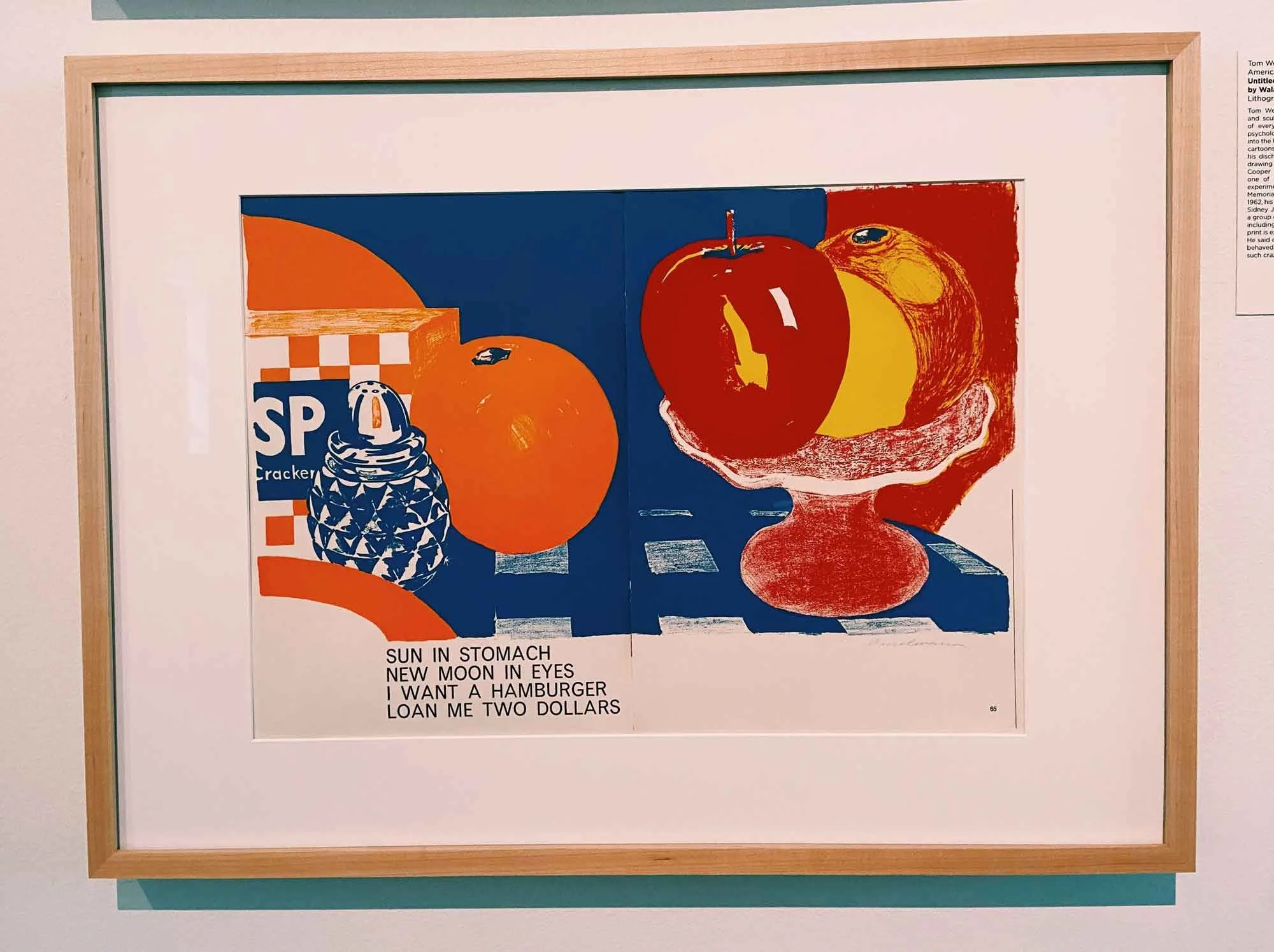 Colorful artwork by Tom Wesselmann features fruit on red pedestal against blue background. Text reads, "SUN IN STOMACH NEW MOON IN EYES I WANT A HAMBURGER LOAN ME TWO DOLLARS"