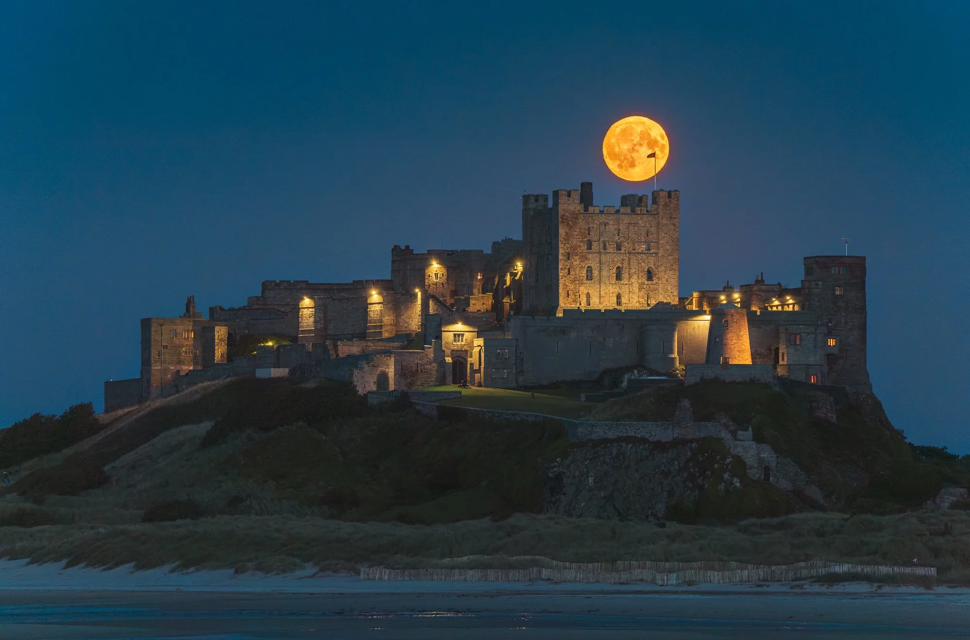 Super moon over Bamburgh Castle on the Northumberland coast, by Jim Scott Photography