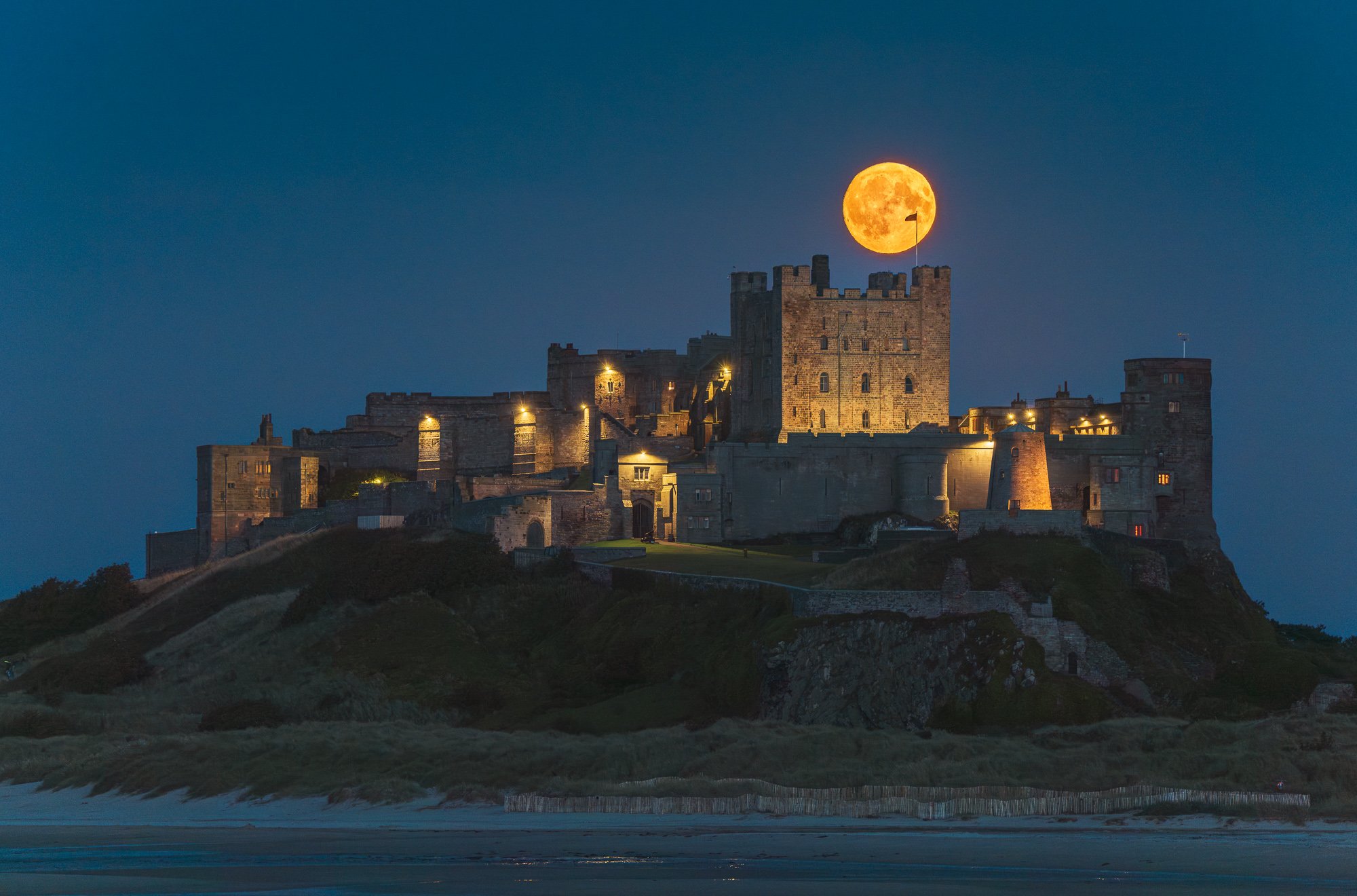 Super moon over Bamburgh Castle on the Northumberland coast, by Jim Scott Photography