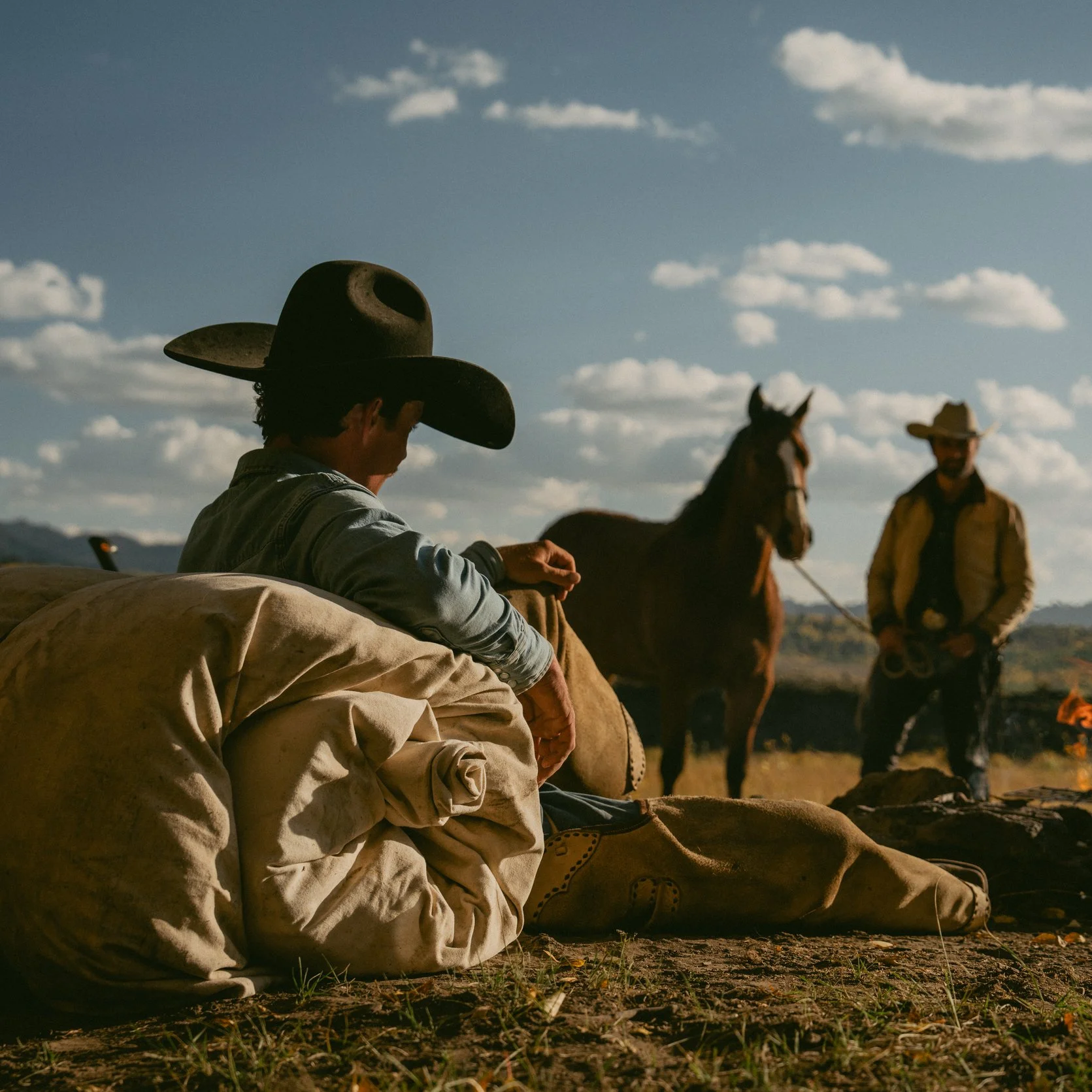 Cowboys sitting around a campfire in Wyoming, by Jim Scott Photography