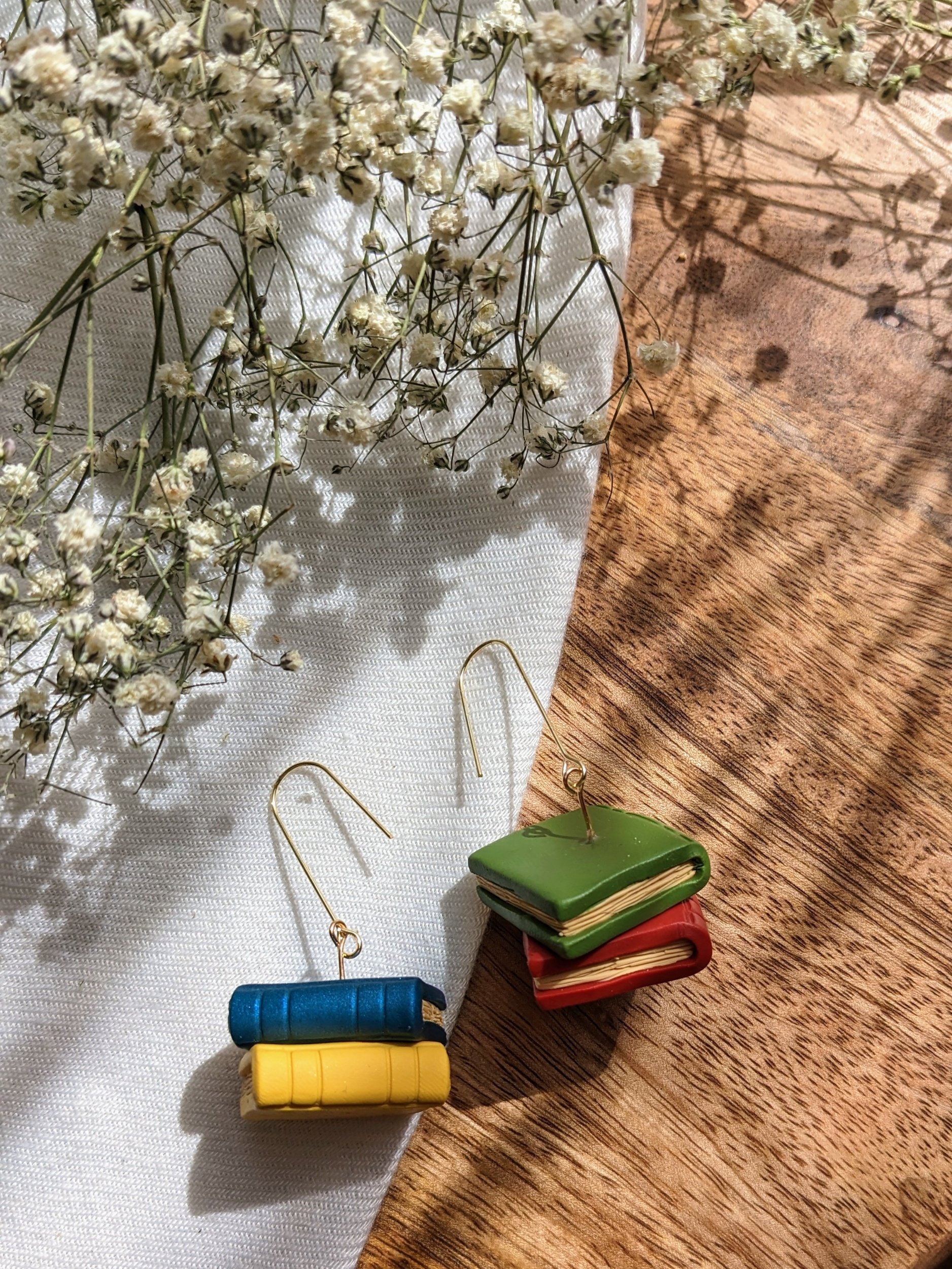Handcrafted polymer clay earrings. Blue/yellow book stack & green/red book stack. All components are gold plated, silver plated, or stainless steel with sensitive ears in mind.