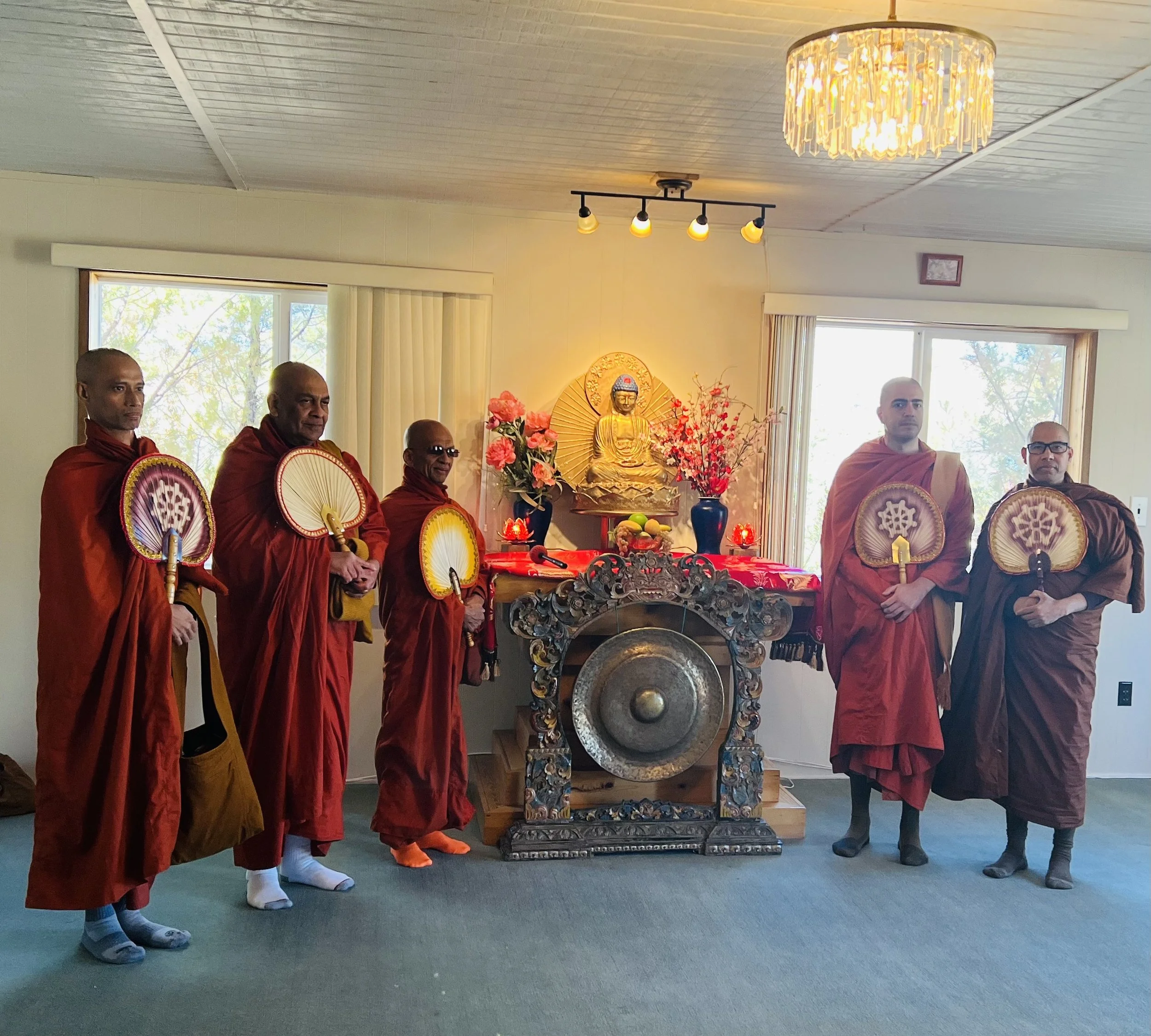 Buddhist Monks standing by the Alter in the Buddhist Temple 