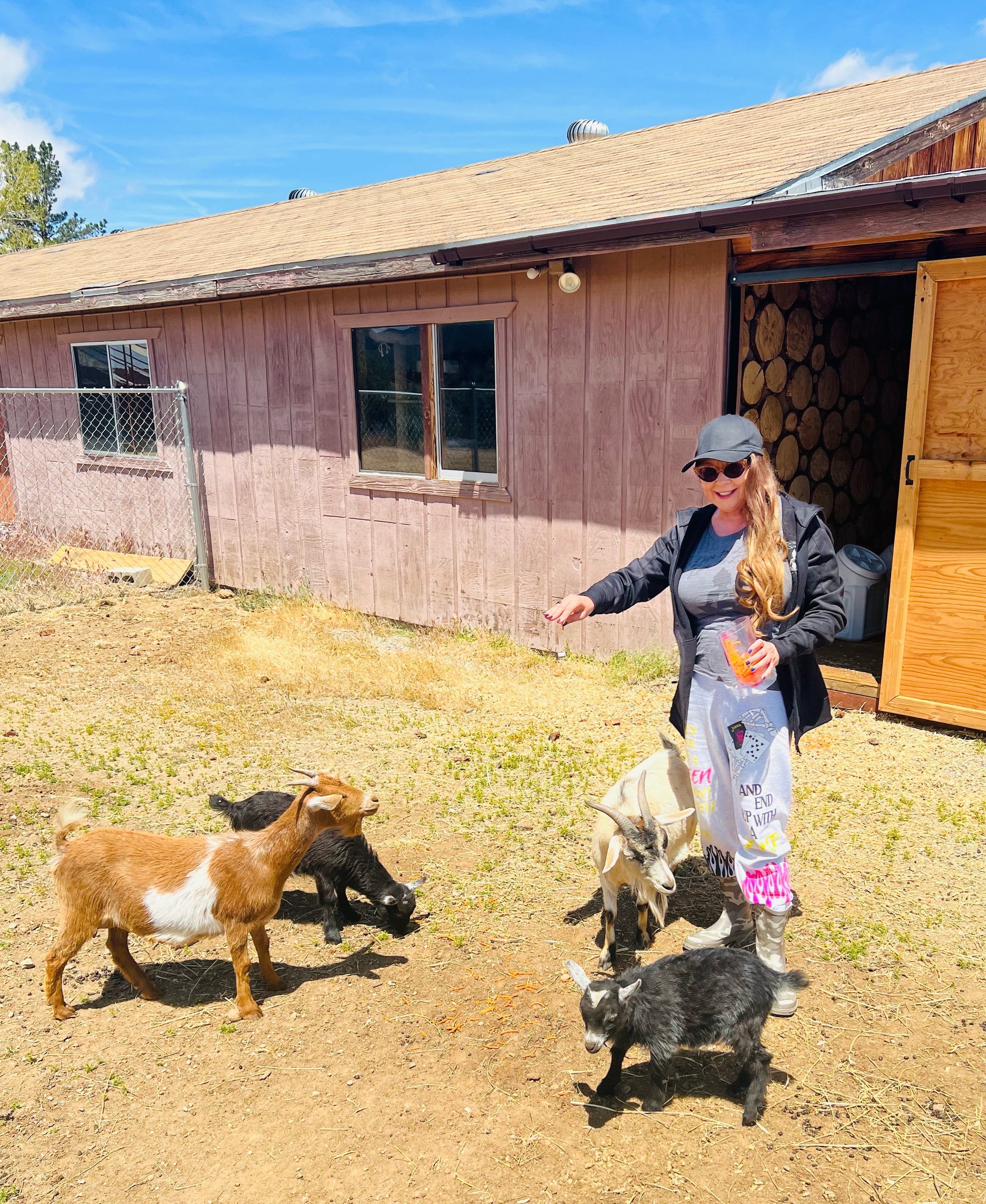 Dr. Ava feeding the goats