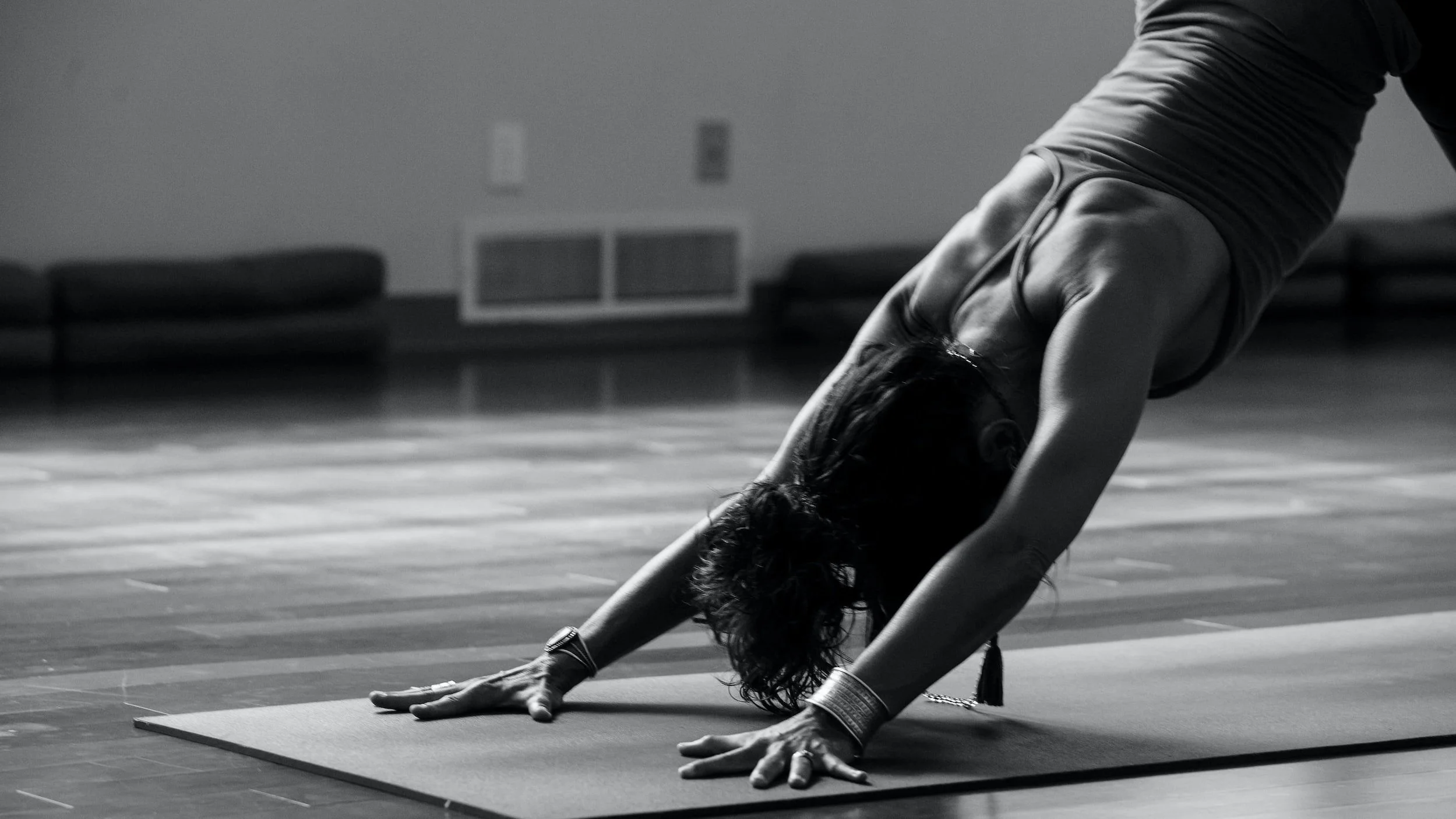 Person in downward dog on yoga mat