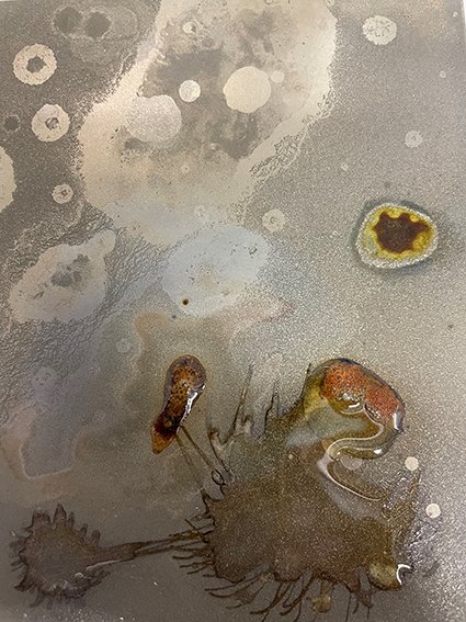 Experimenting with chemicals on steel plate