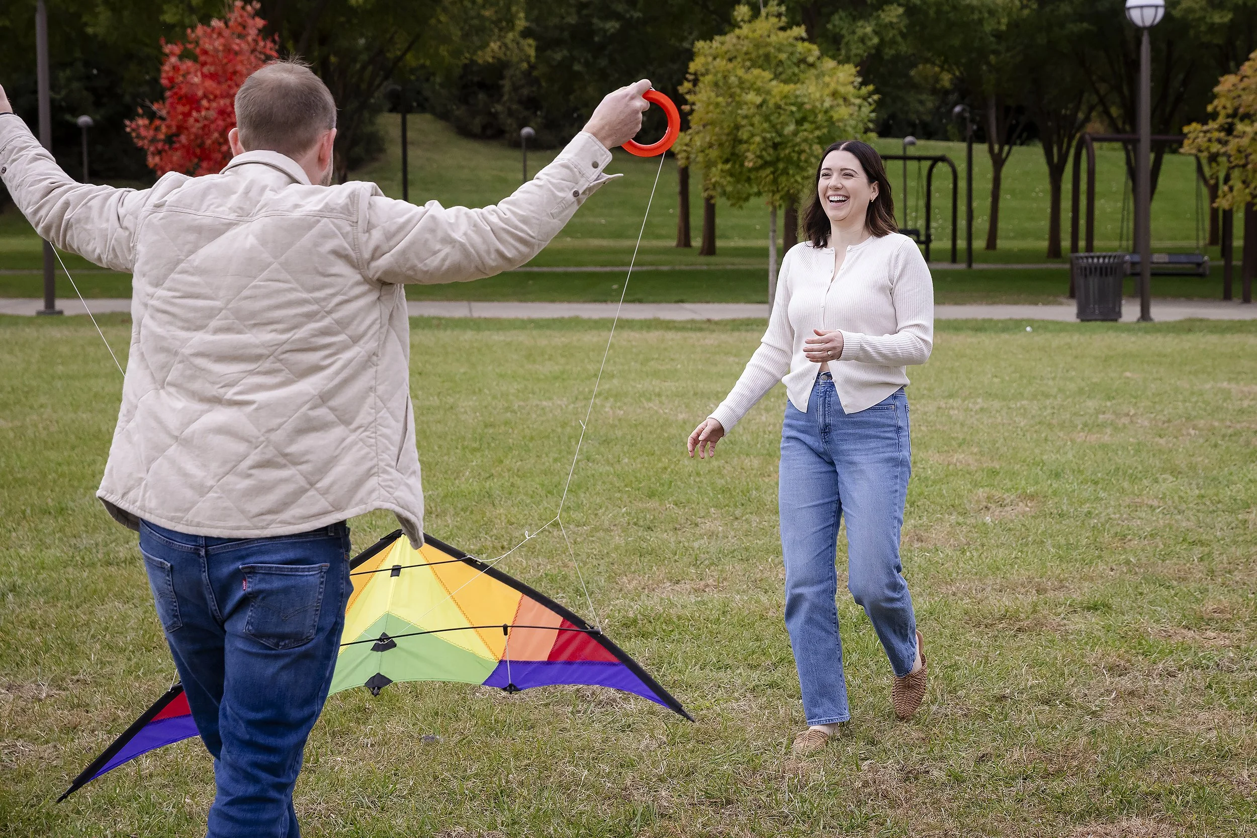 girl-laughs-while-flying-kite-Louisville-anniversary-session.JPG