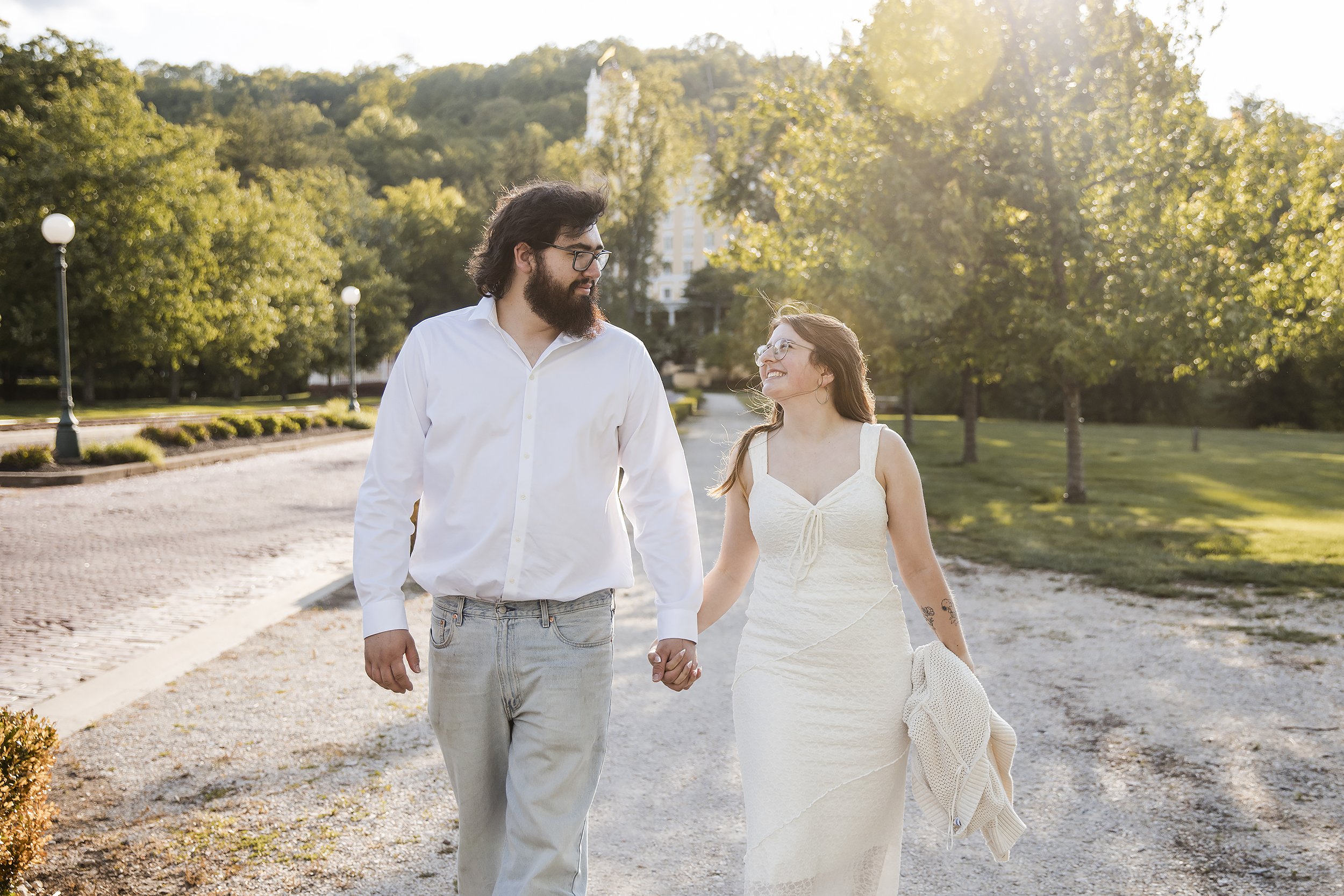 Couple hold hands and walk West Baden Engagement.JPG
