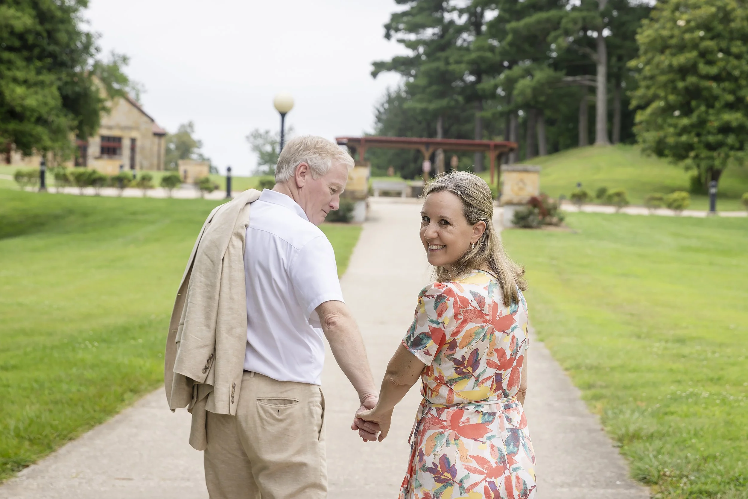 Couple hold hands and walk Saint Meinrad Engagement Portraits.JPG