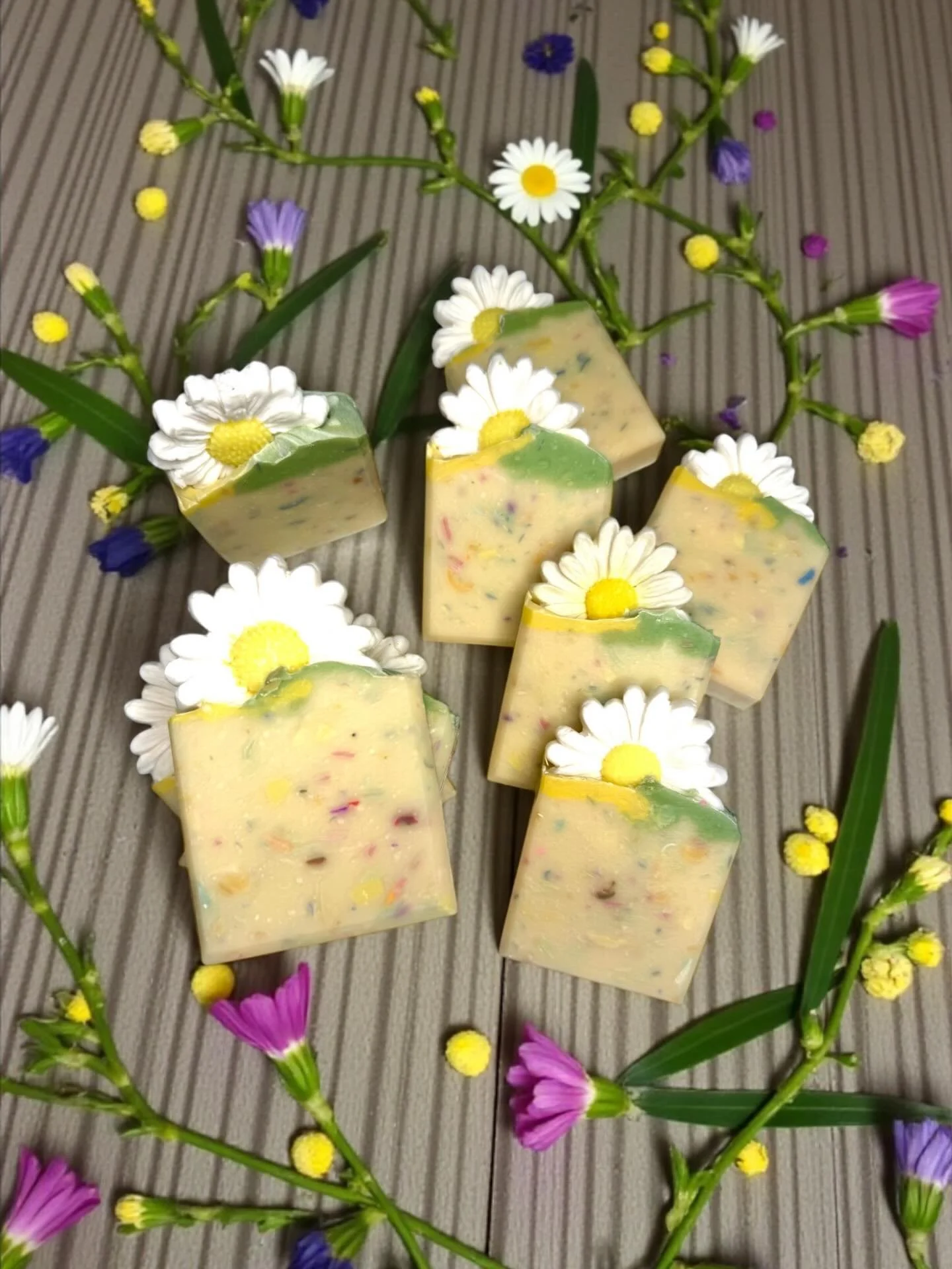 🌼daisies for days
Scented in Lemon verbena, these vegan soaps are bright and fresh&mdash;a burst of sweetness in your shower. 

Each bar is topped with a soap daisy and packed with skin-loving oils and butters. Organic coconut milk gives this bar a 