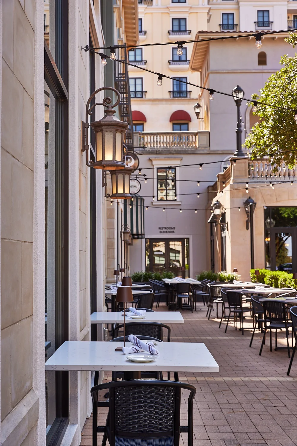 Piatti La Cantera patio with bistro lighting