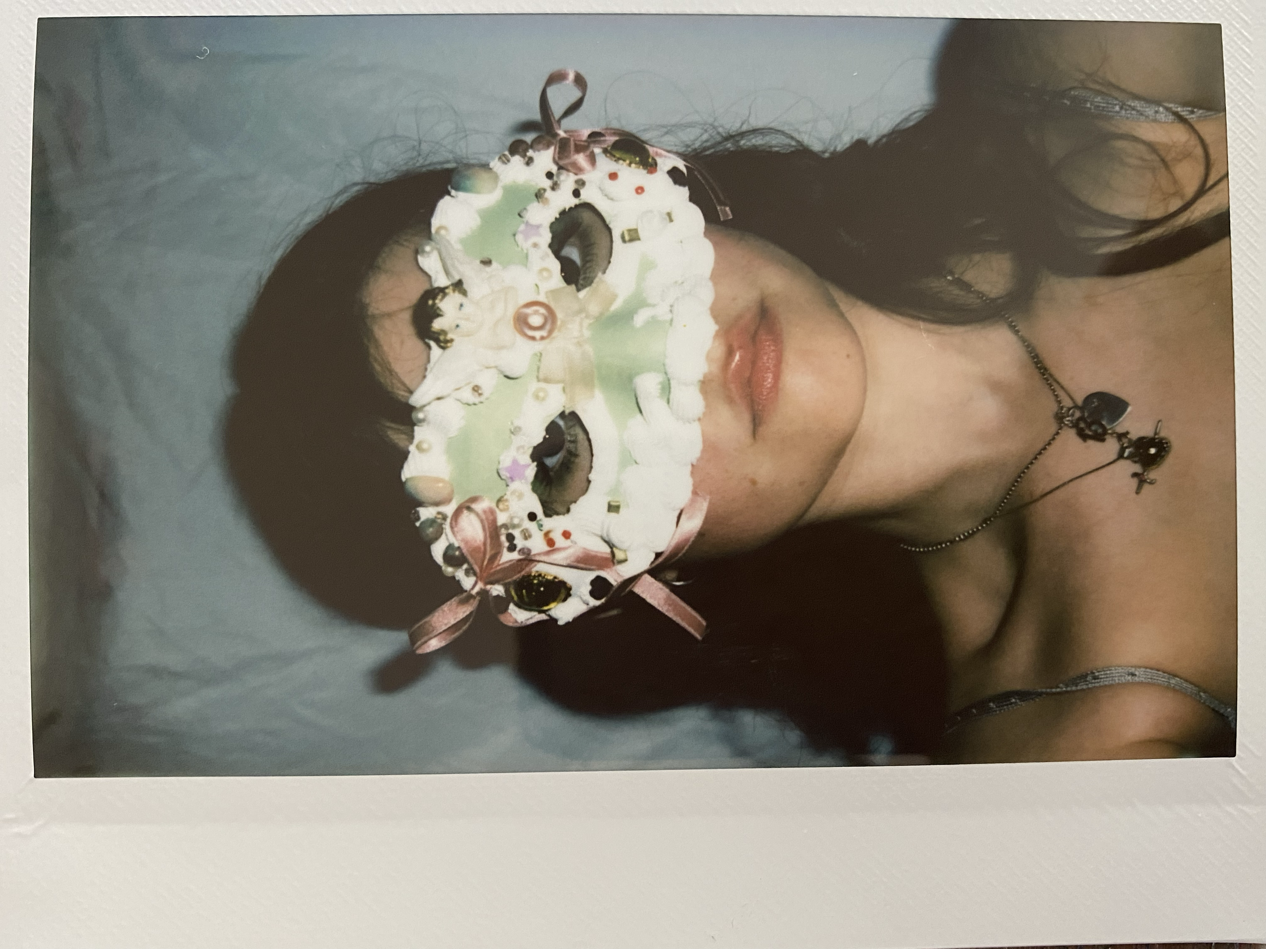 a green masquerade mask with frosting