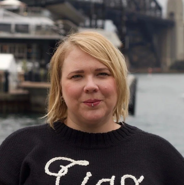 A headshot of a white woman in her mid-40s with short blonde hair and a silver lip ring.