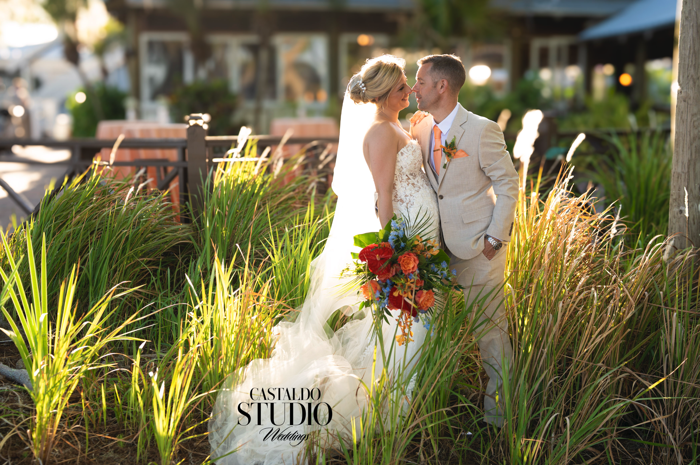Bride and groom sharing an intimate golden hour moment surrounded by tall tropical grass at Paradise Cove Orlando, captured by Castaldo Studio Weddings, luxury wedding photographers serving Orlando and worldwide destinations.