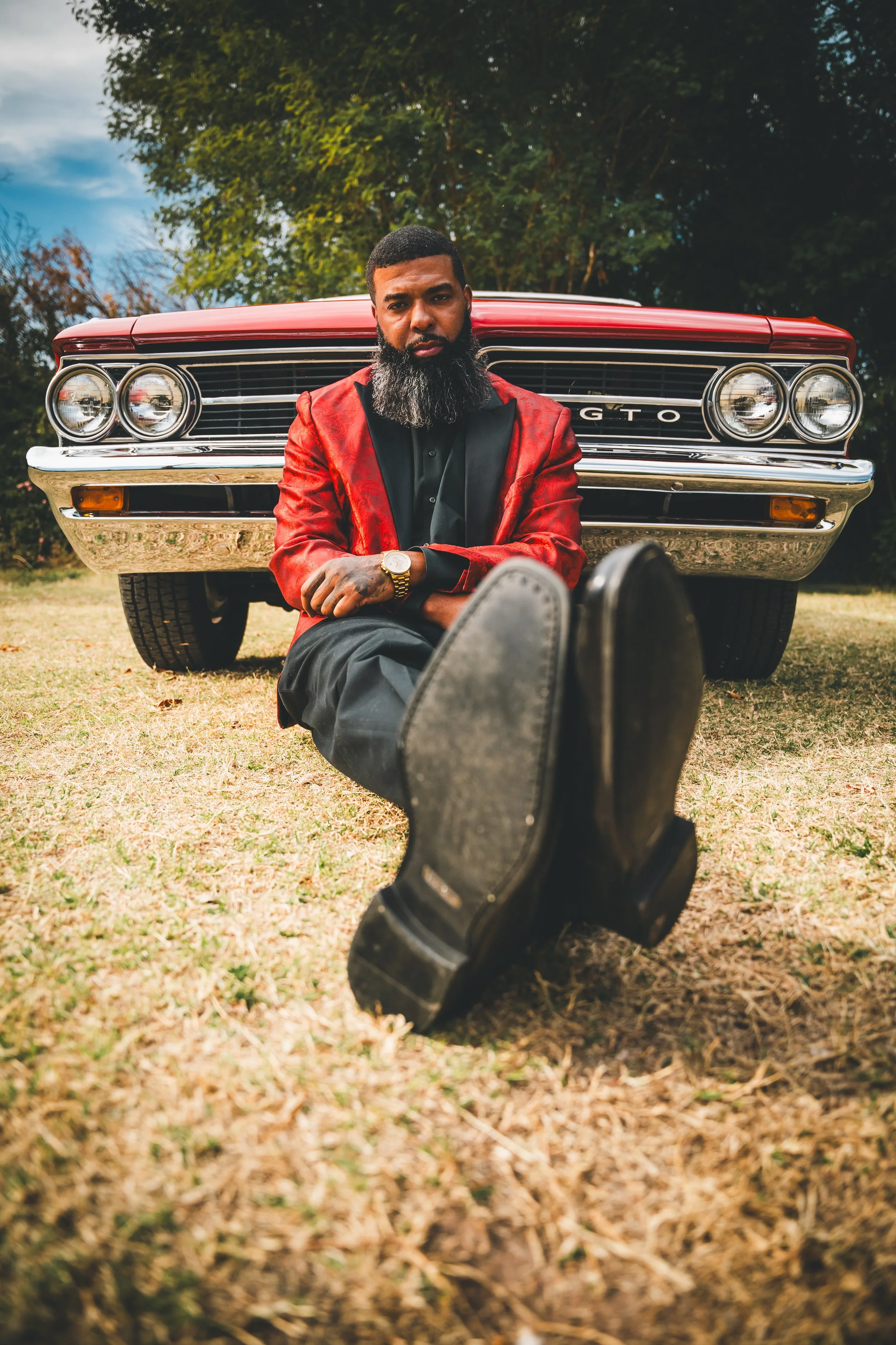 low angle portrait red GTO dapper man.jpg