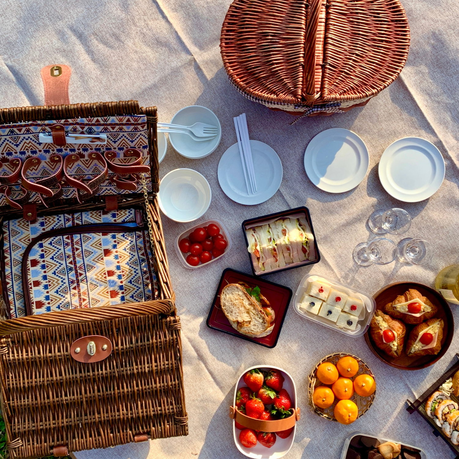 A fun picnic basket with cheese and little bowl of goodies