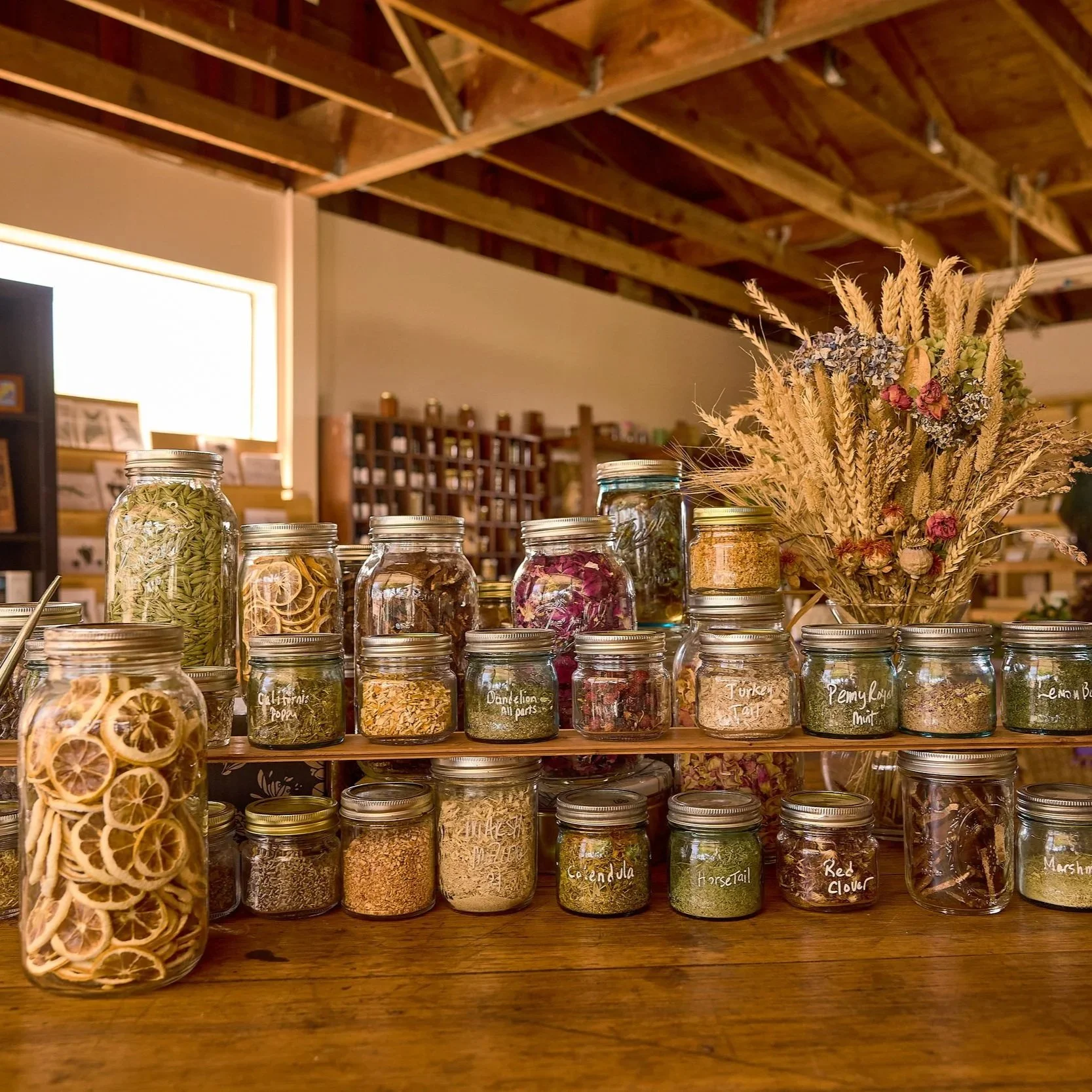 Jars of dried herbs and spices on wooden shelves in Casari Ranch Farmstand in Santa Rosa/Sebastopol