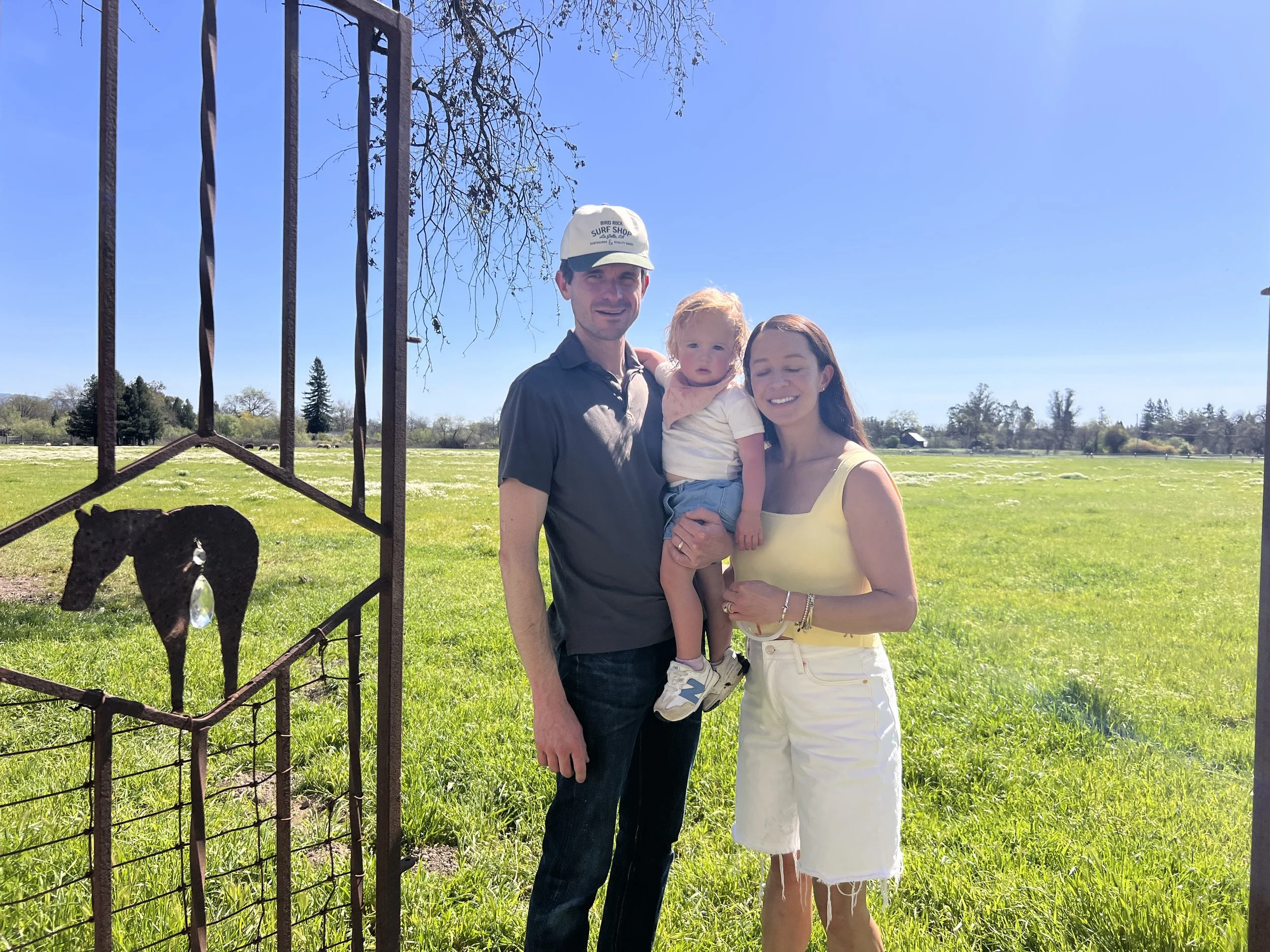 mom, dad and daughter at the grassy field.jpeg