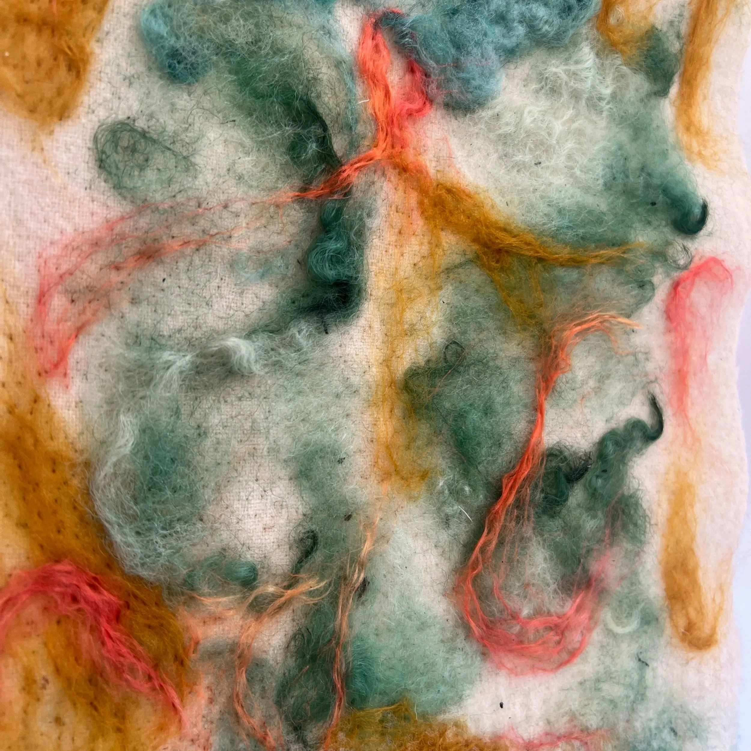 colorful wool panel with orange and green fibers
