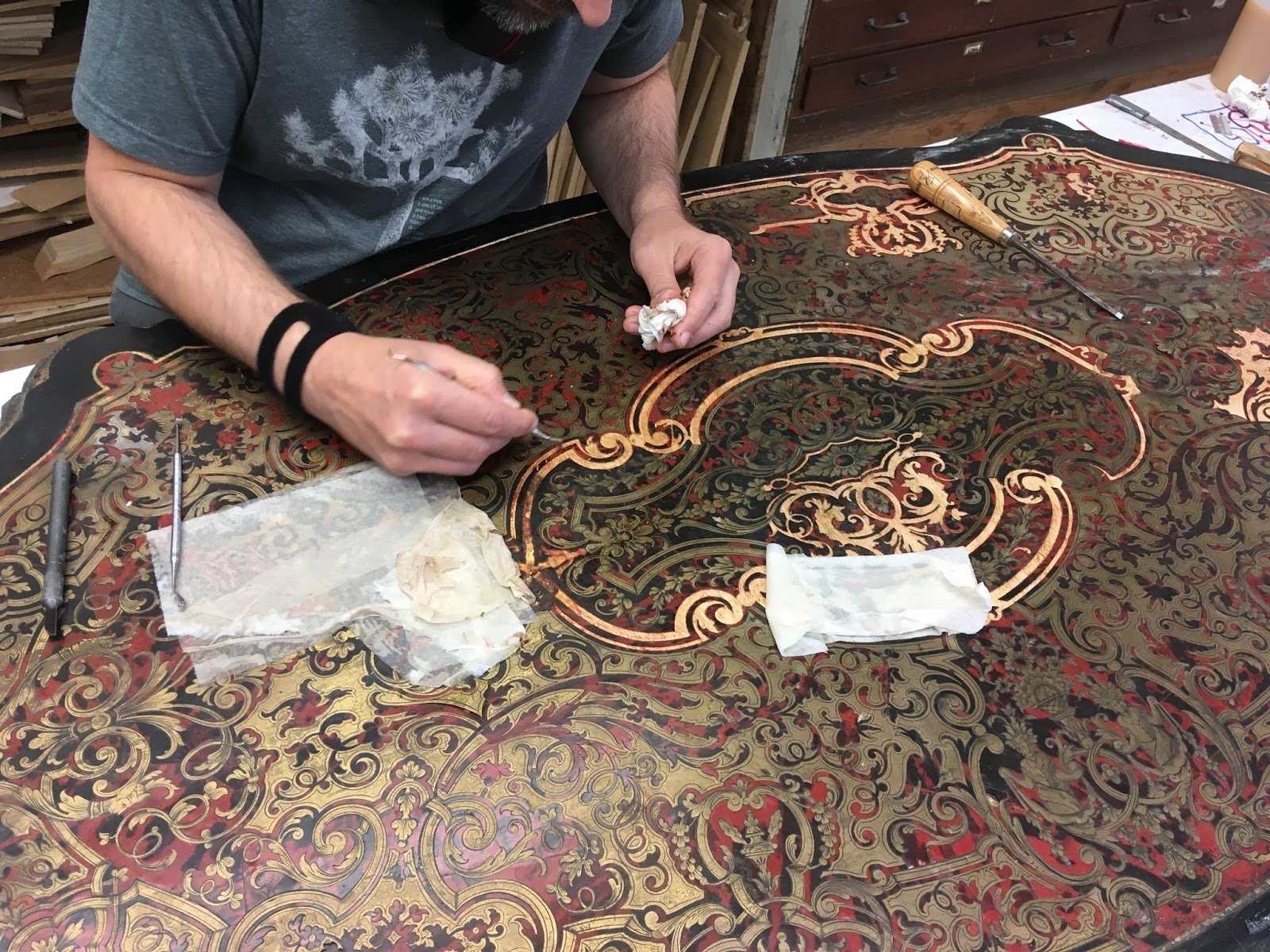 Cleaning of Boulle marquetry cavities to provide proper adherence to inlay the lose brass elements.