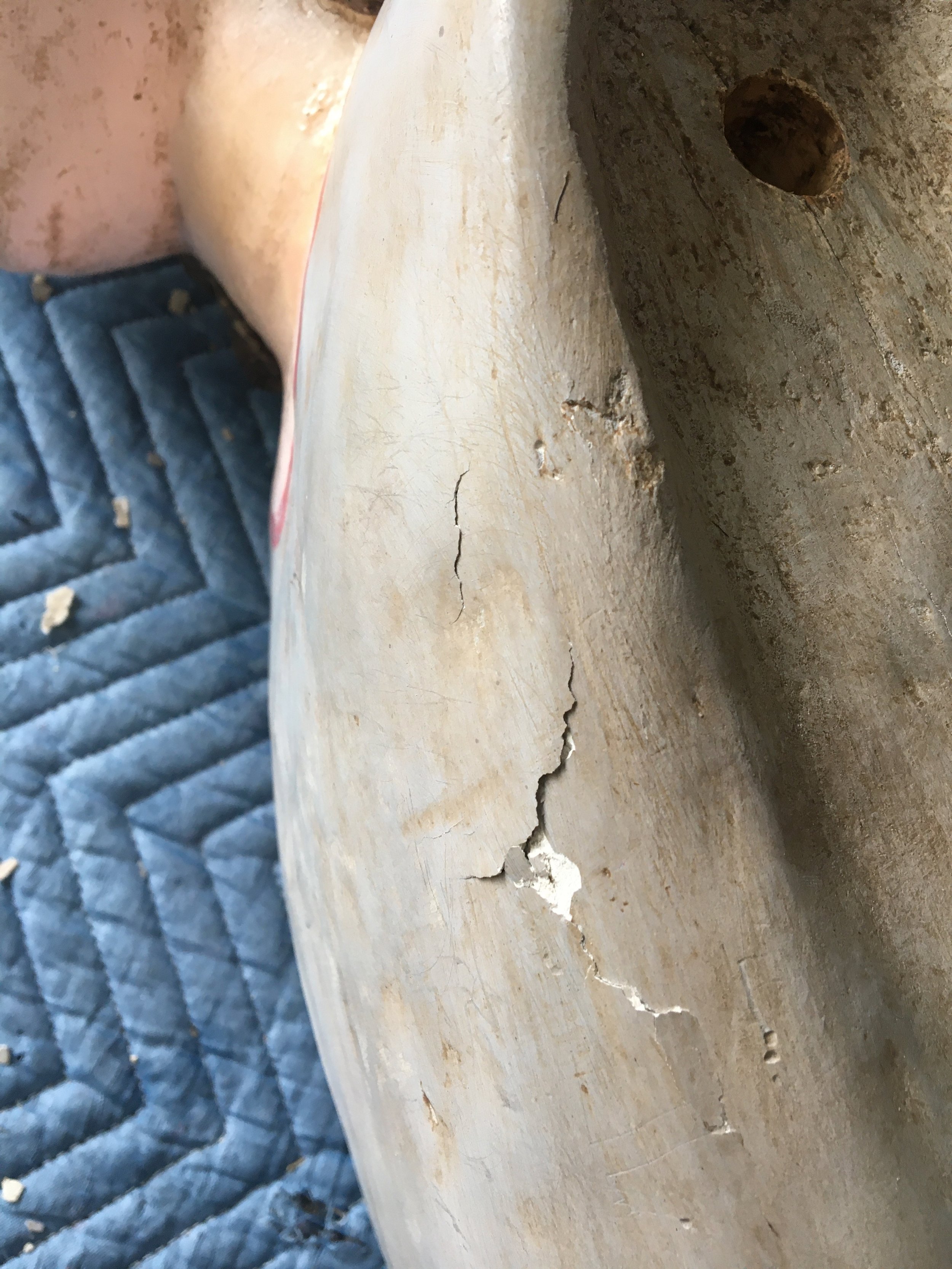 When the wood dried it retracted so much that it left pockets of air under the gesso.