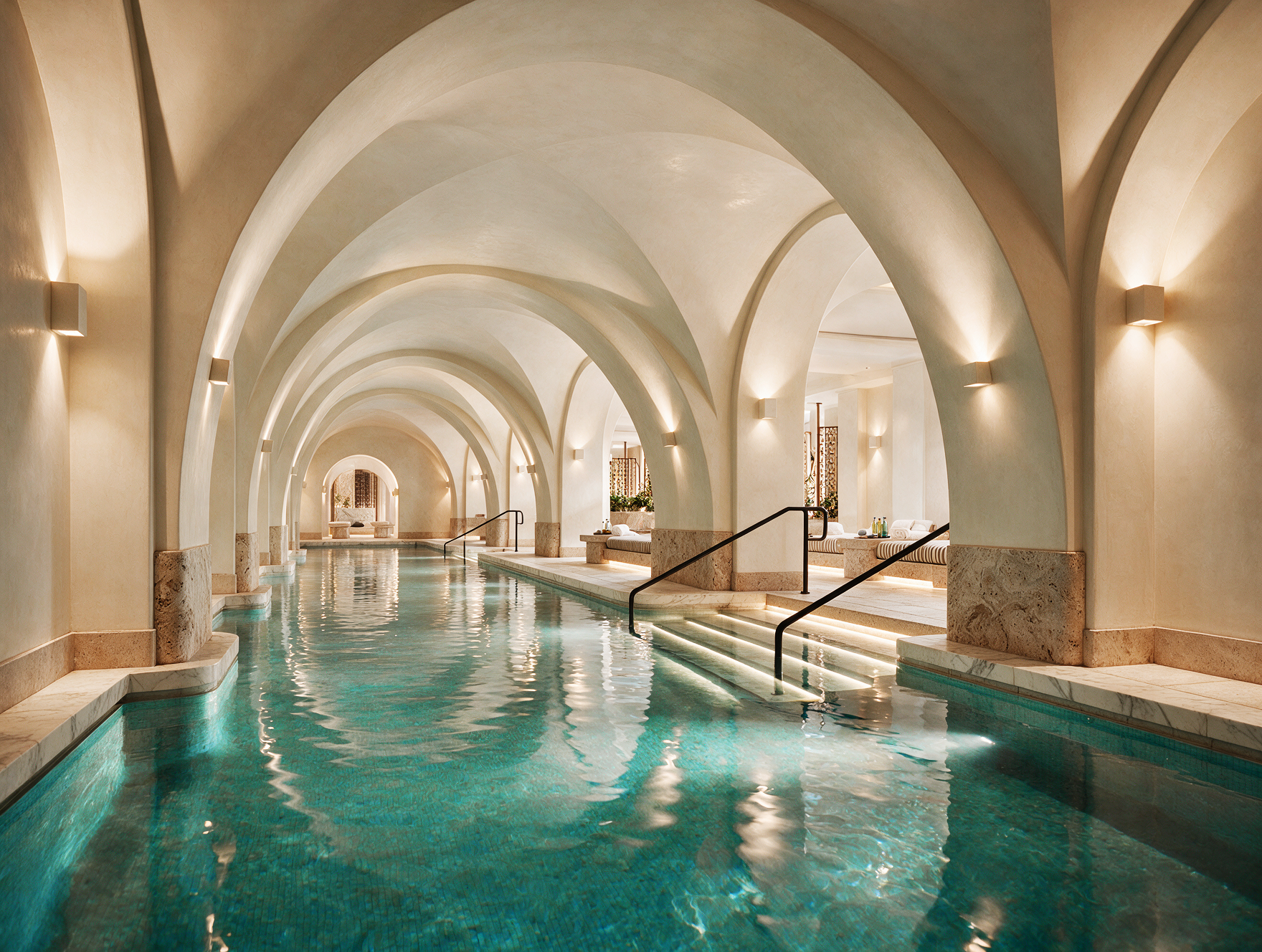 Indoor wellness pool with arched architectural ceilings, tranquil lighting, and luxury spa-inspired design.