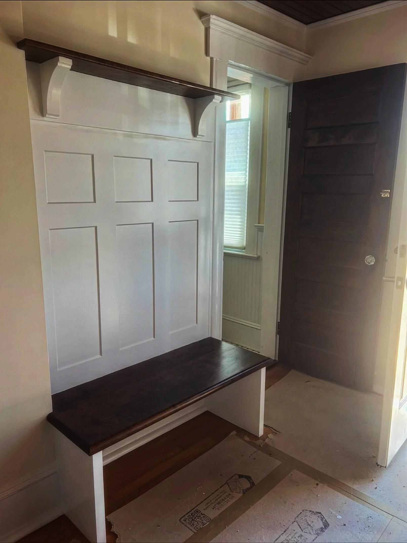 Clean entryway upgrade &mdash; custom bench, crisp paneling, and a space that finally works.