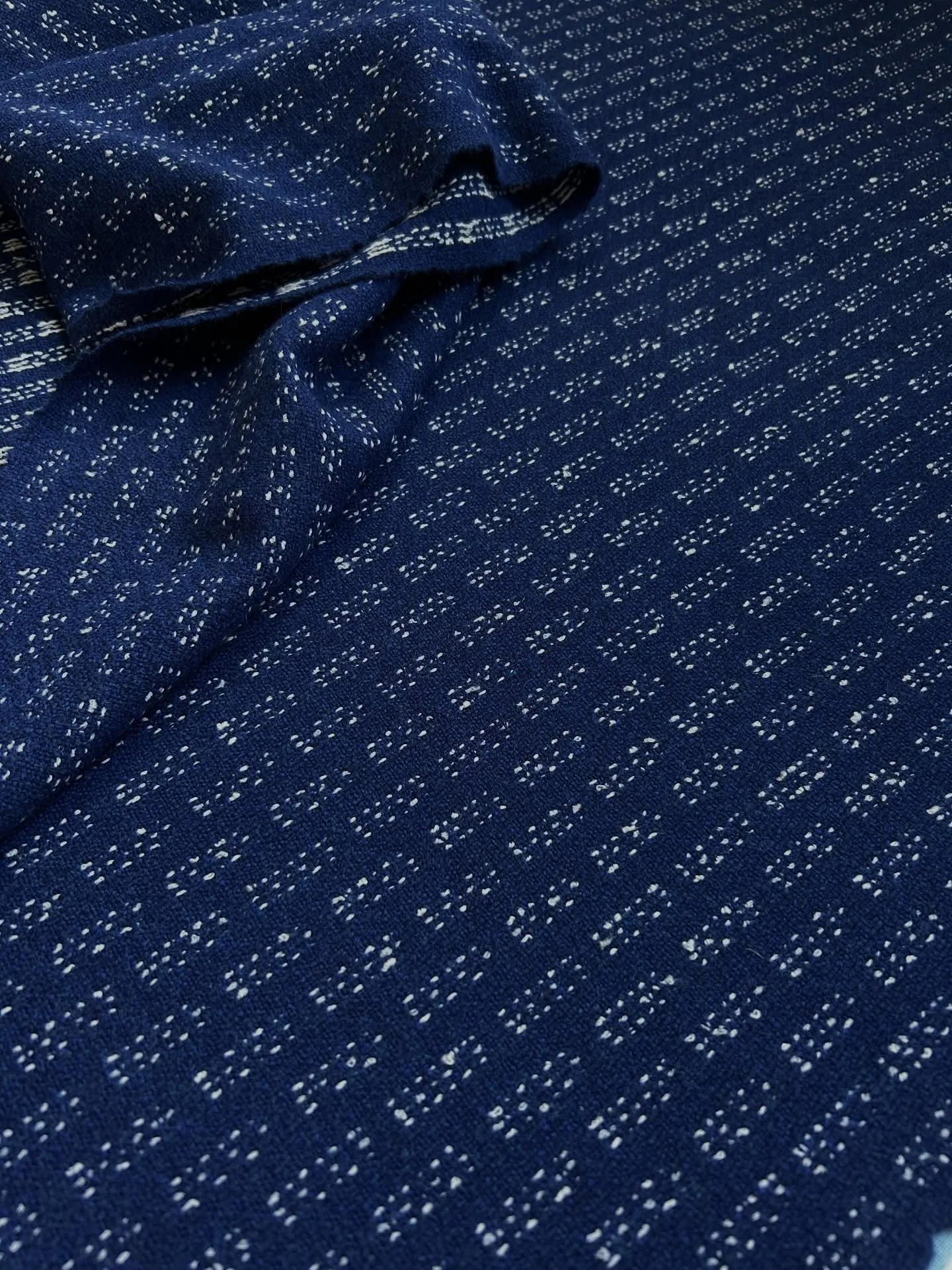 Lambswool &amp; cotton boucl&eacute;

This commission came off the loom earlier this week. After soaking and washing the cloth, it is slowly finished by hand with multiple stages of steaming &amp; pressing.