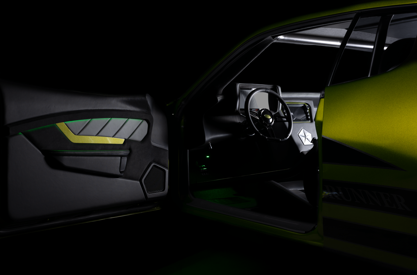 Inside view of a race car showing the dashboard, steering wheel, and door with green accents.