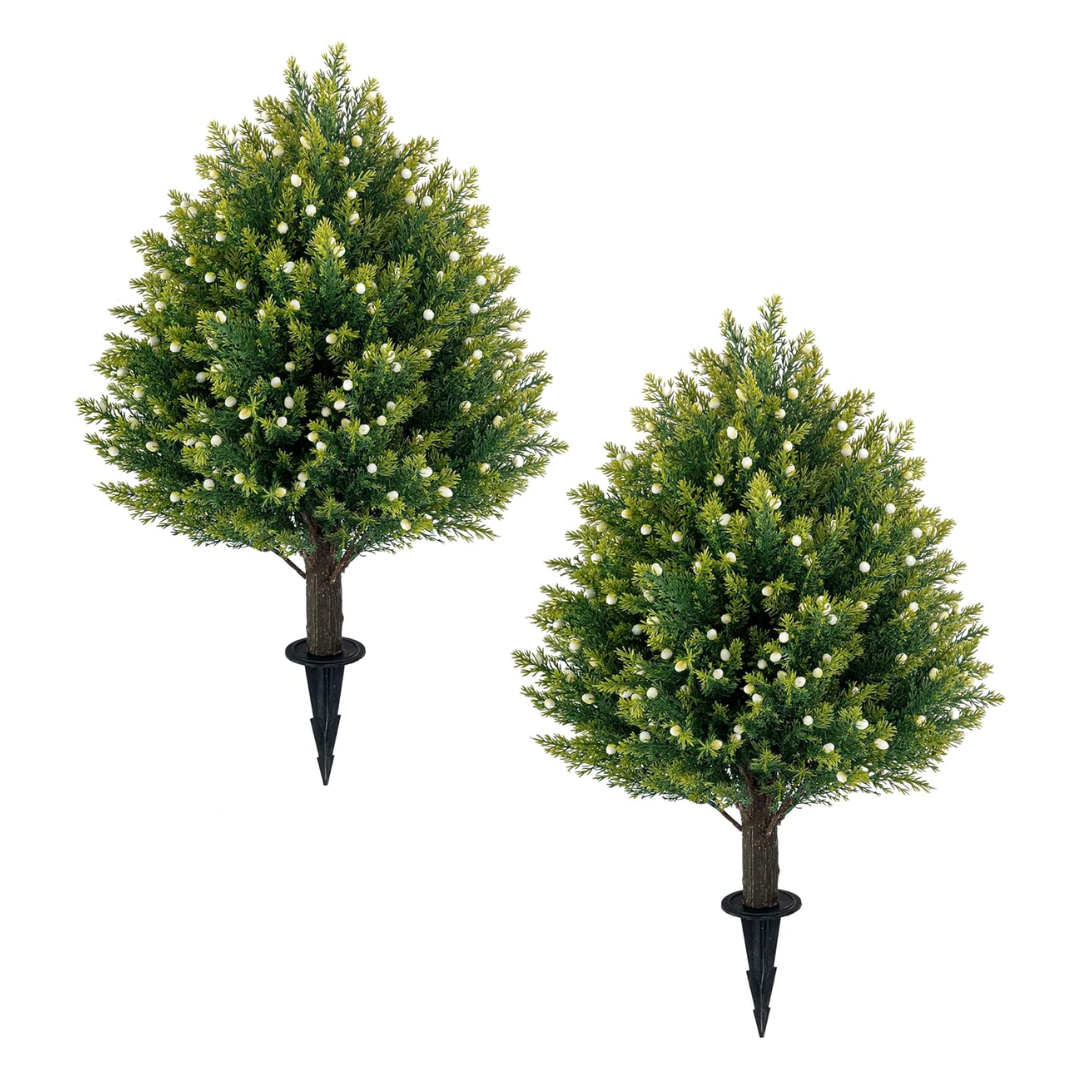 Two small artificial Christmas trees decorated with white ornaments, set against a white background.