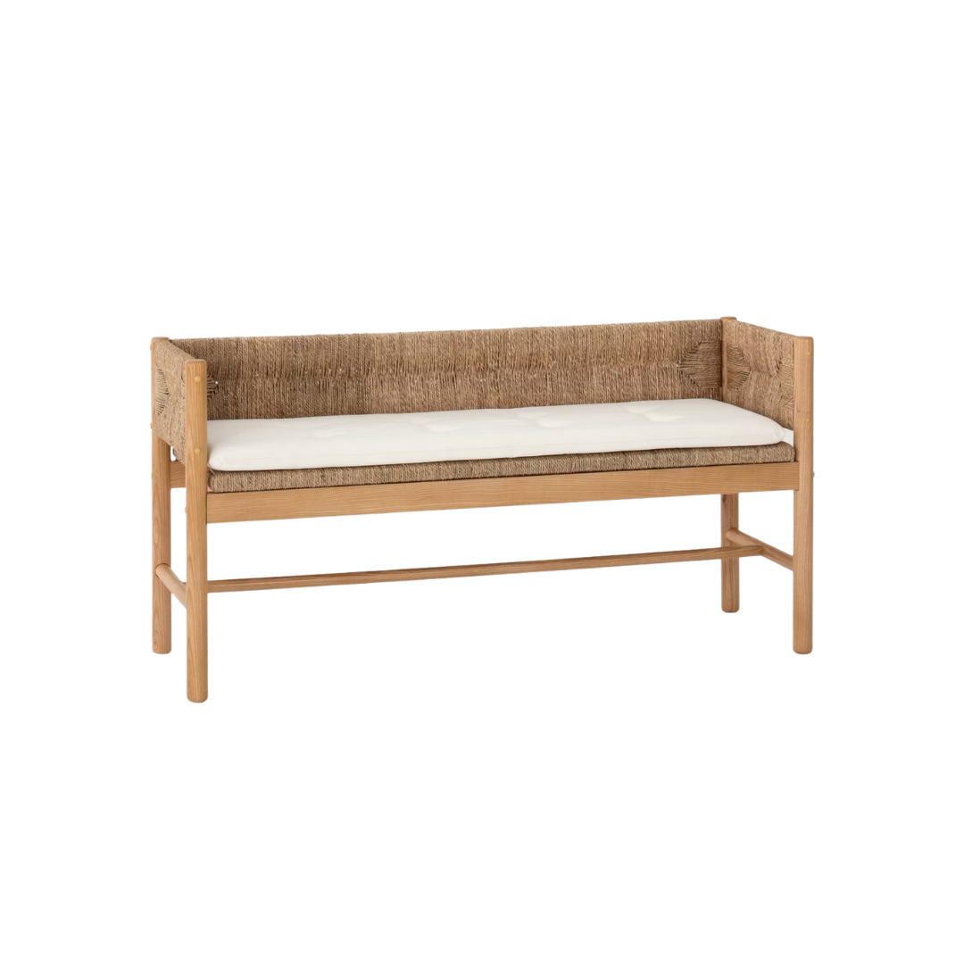 Wooden bench with woven backrest and white cushion.