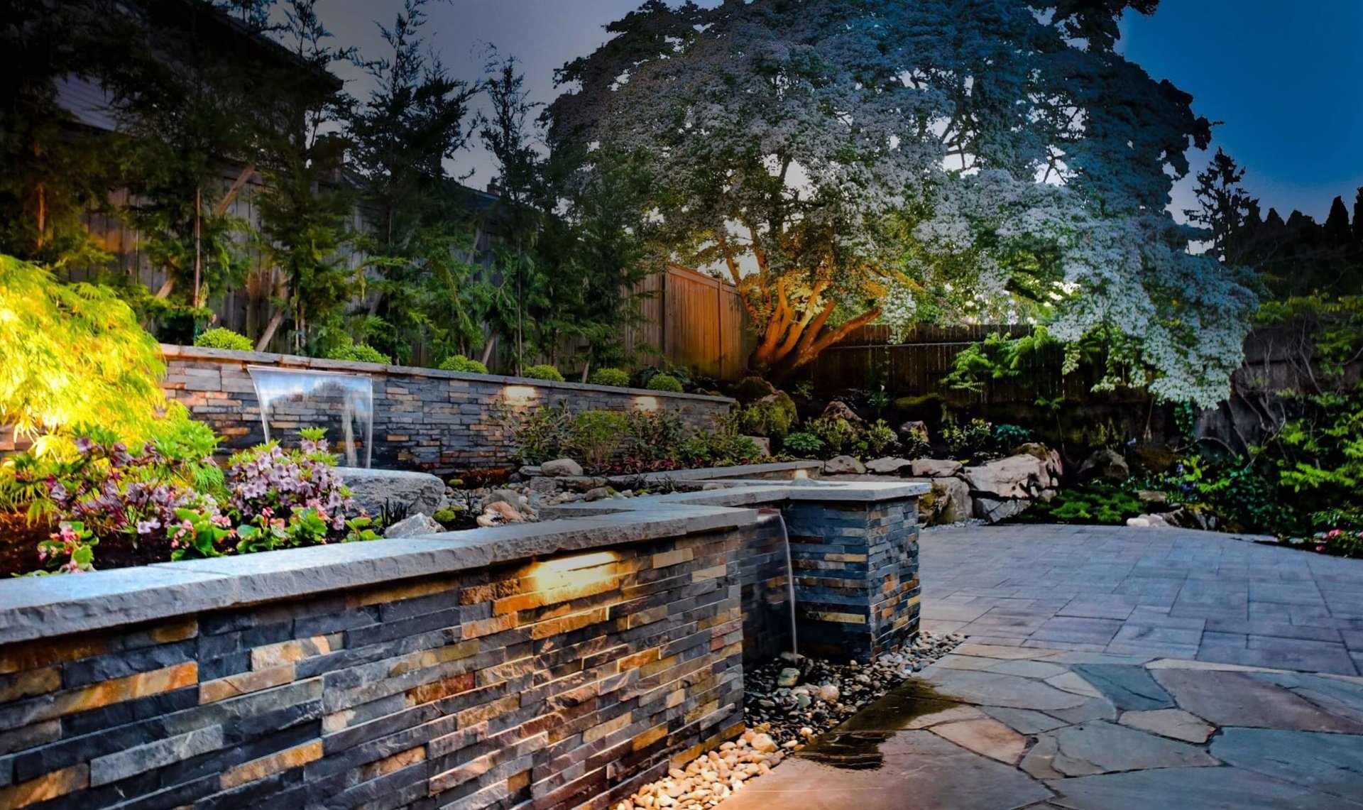 Stunning paver patio with retaining wall and outdoor lighting in Kirkland WA