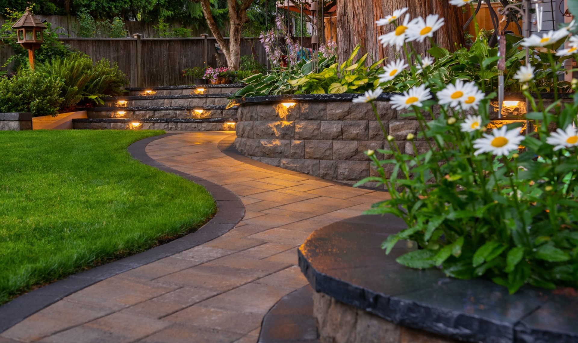 Landscape design with outdoor lighting and retaining wall in Bellevue WA