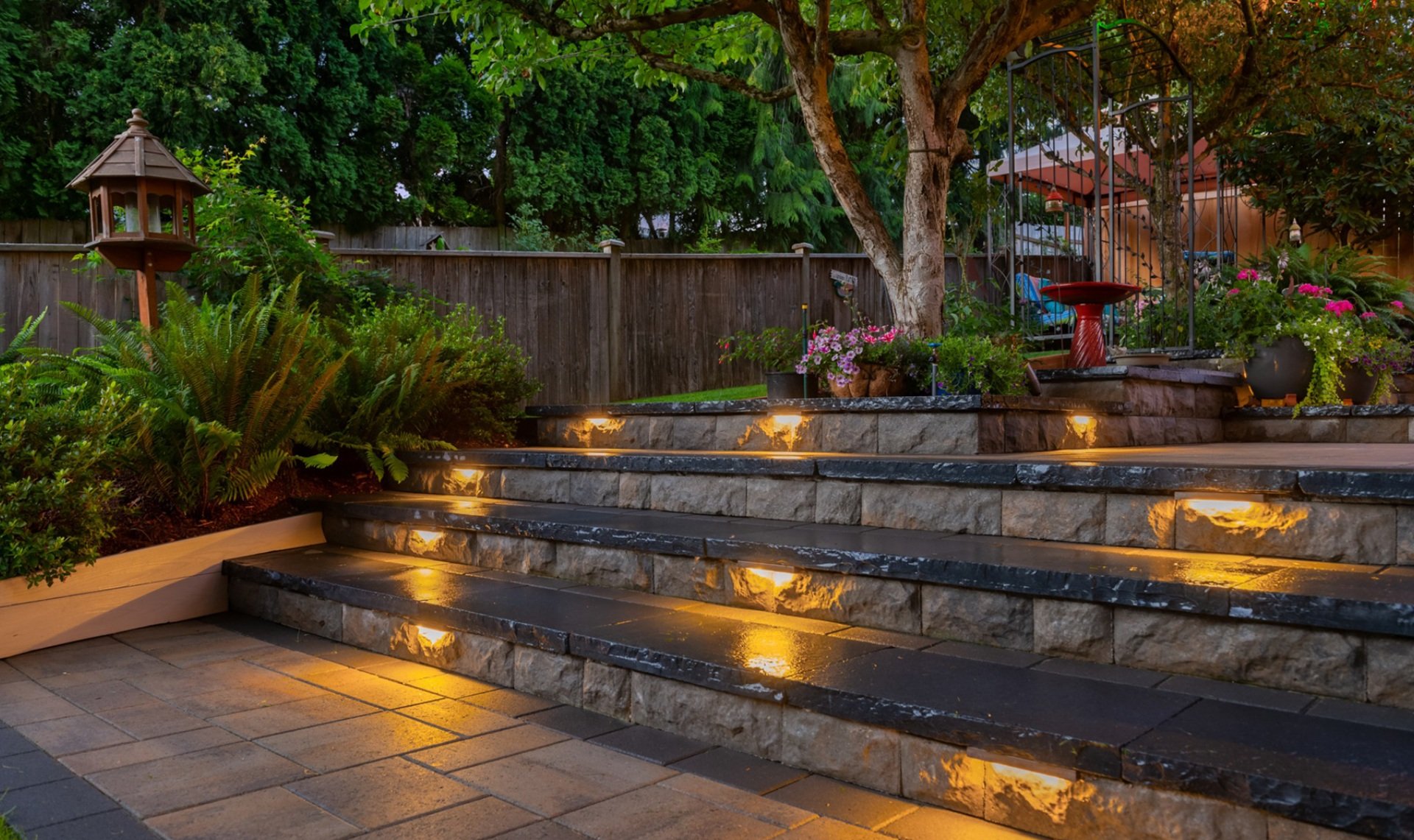 Redmond, WA landscape design, paver patio, pergola, artificial turf, outdoor kitchen, lighting