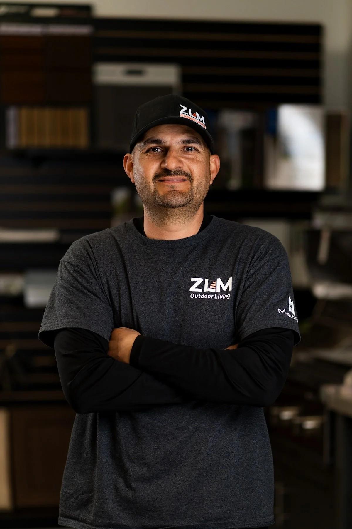 Man with beard wearing black hat and gray t-shirt with ZLM logo