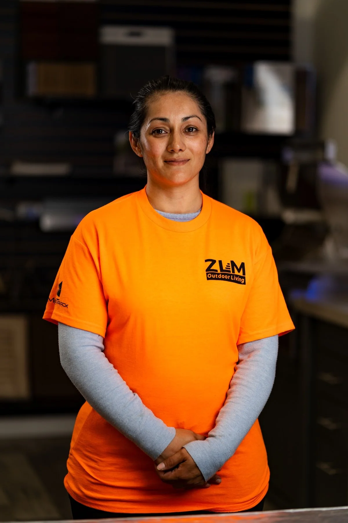 Woman in orange t-shirt with ZLM logo