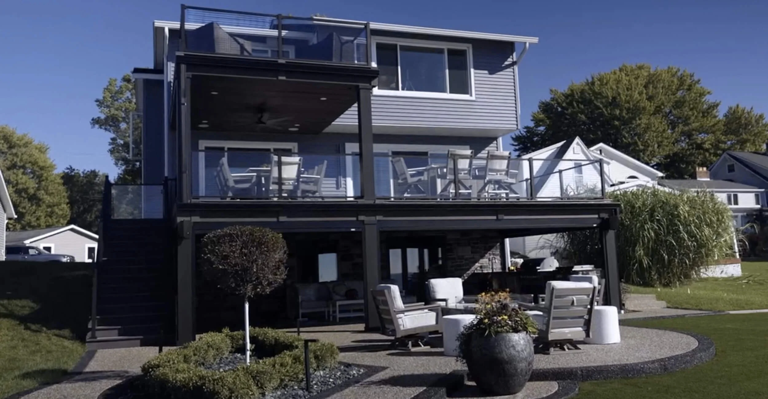 Multi-level entertaining area showcasing elevated backyard oasis design in Troy, Shelby Township, and Rochester Hills, MI with expansive patio surfaces